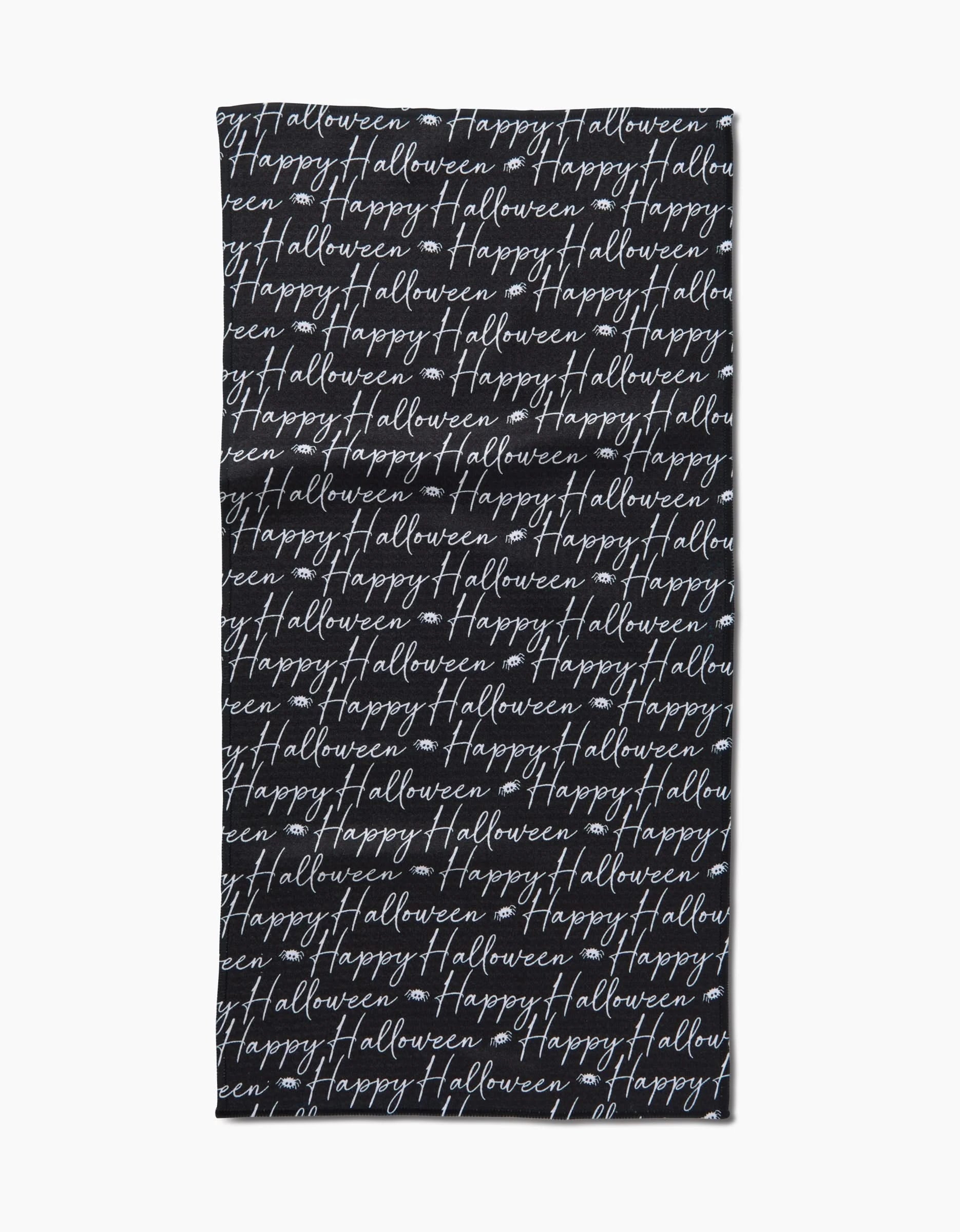 The Geometry Halloween Script Black towel is a black rectangular bar towel with “Happy Halloween” written repeatedly in white cursive across its surface.
