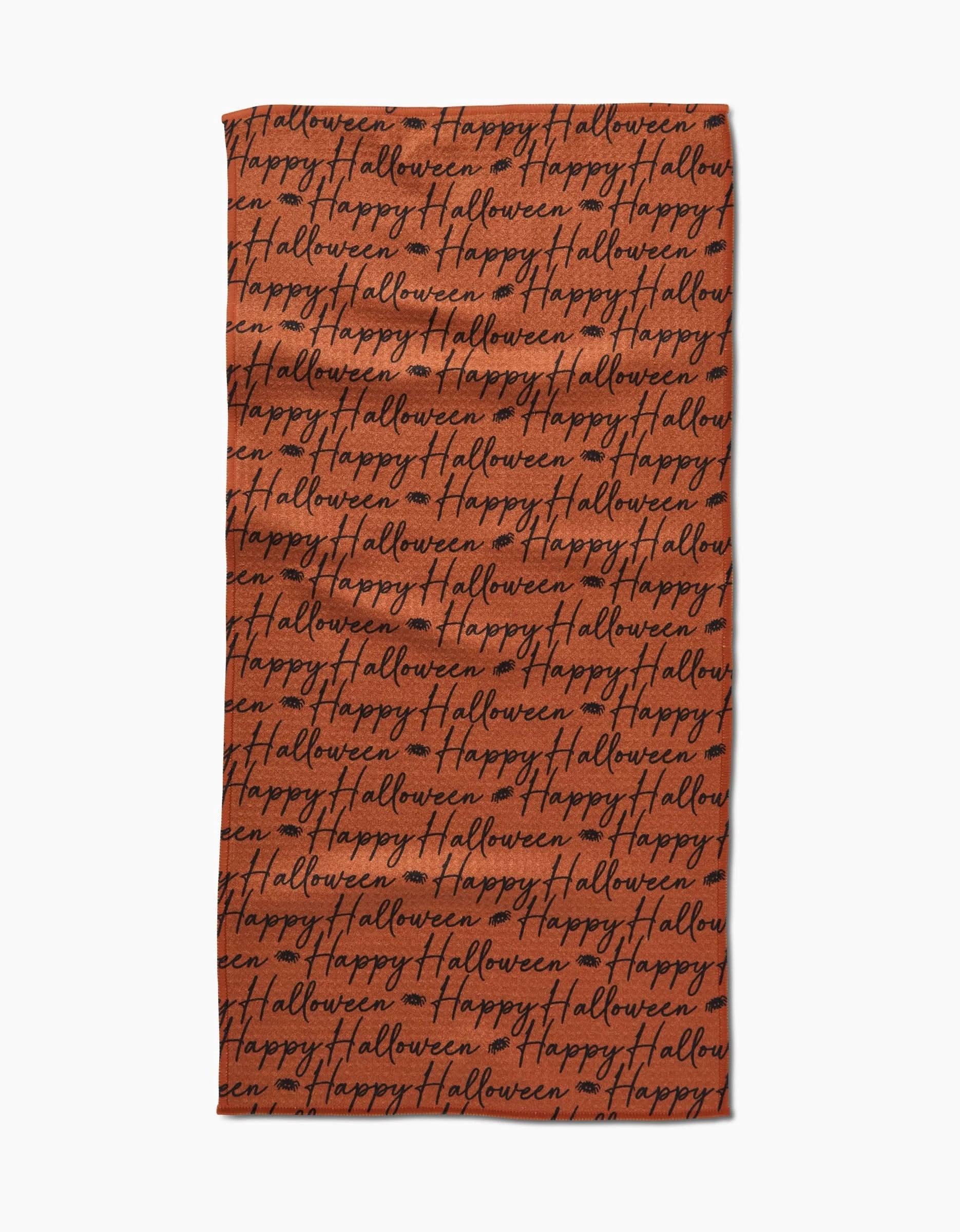 The Geometry Halloween Script Orange towel is a rectangular, ultra-absorbent orange towel featuring Happy Halloween in black cursive covering the whole surface.