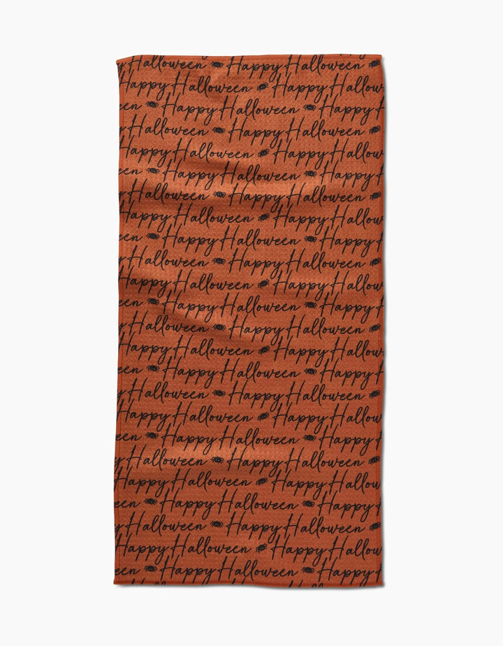The Geometry Halloween Script Orange towel is a rectangular, ultra-absorbent orange towel featuring Happy Halloween in black cursive covering the whole surface.