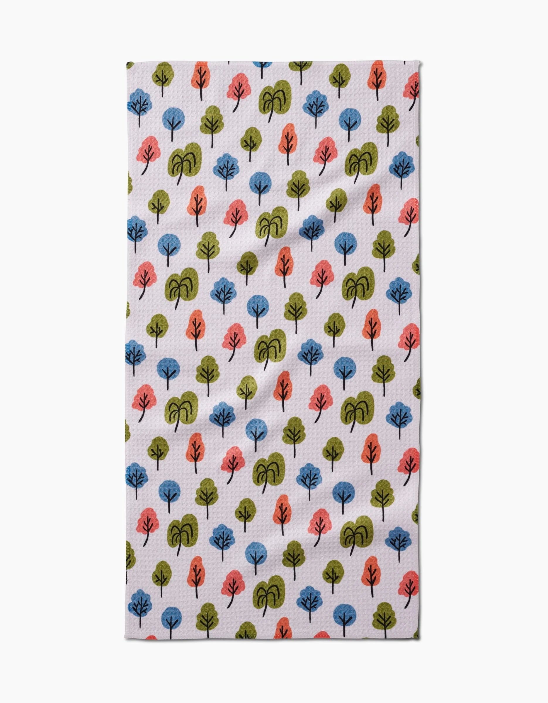 The Kayla Ann Happy Trees Bar Towel features a repeating pattern of small, stylized blue, green, and orange trees on white Geoweave fabric.