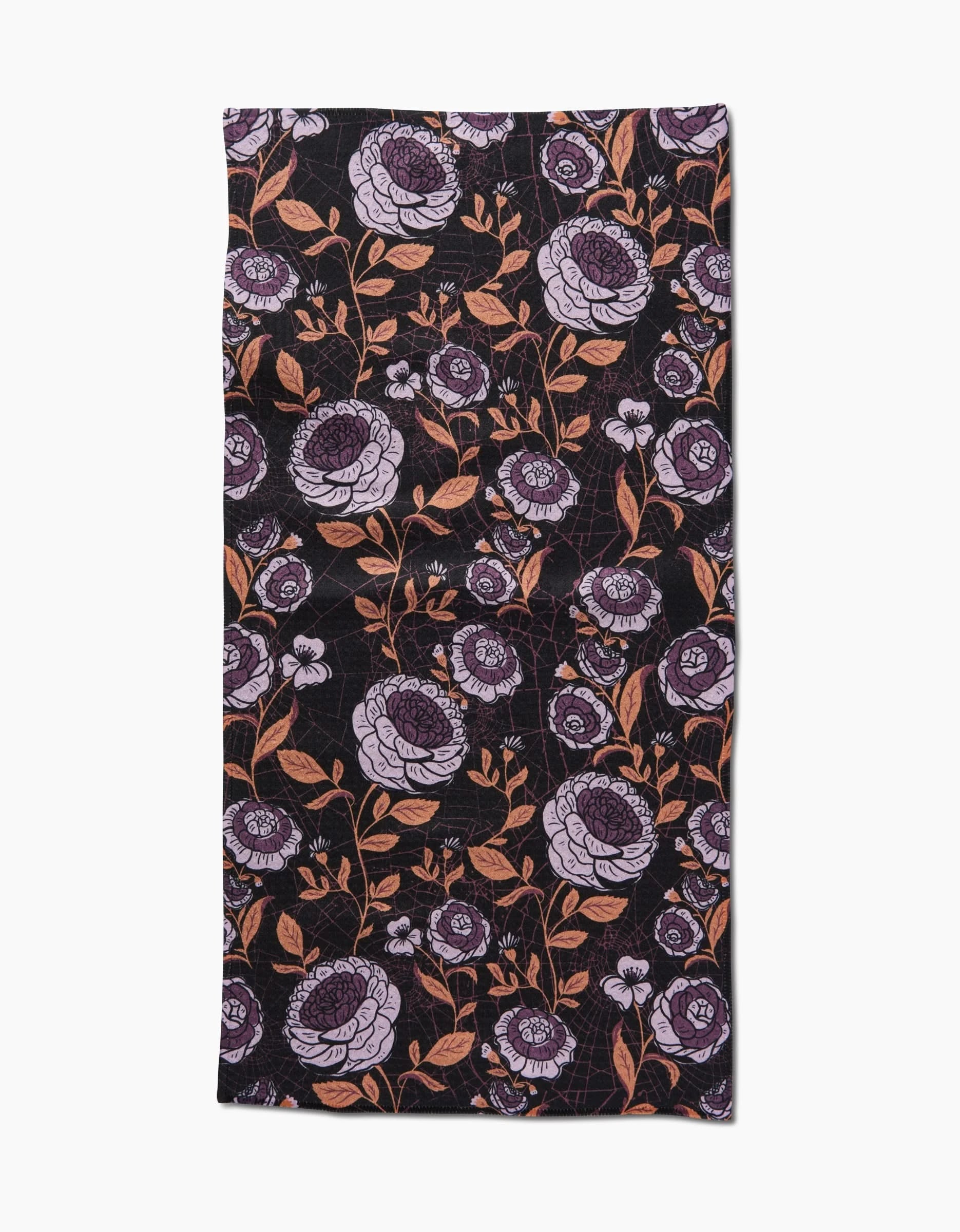 The Haunted Roses towel by Danelys Sidron is a rectangular black ultra-absorbent towel featuring a floral pattern with large purple and small pink flowers, plus brown leaves and stems evenly spread across the surface.