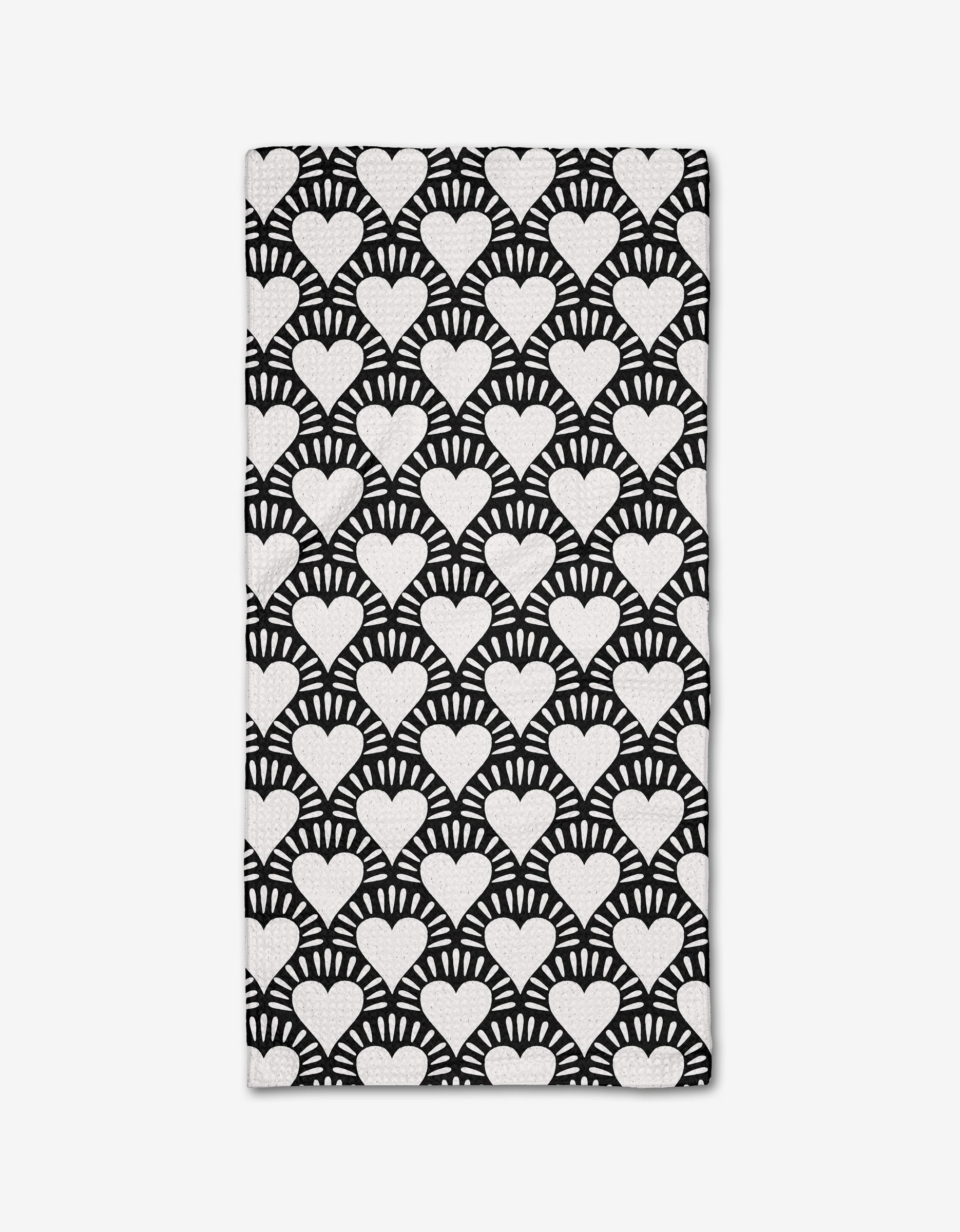 The Heartthrob Onyx bar towel by Charlie Rowan Designs is made from Geoweave fabric and showcases bold, high-contrast white hearts with radiating lines on a black background for a striking geometric look.