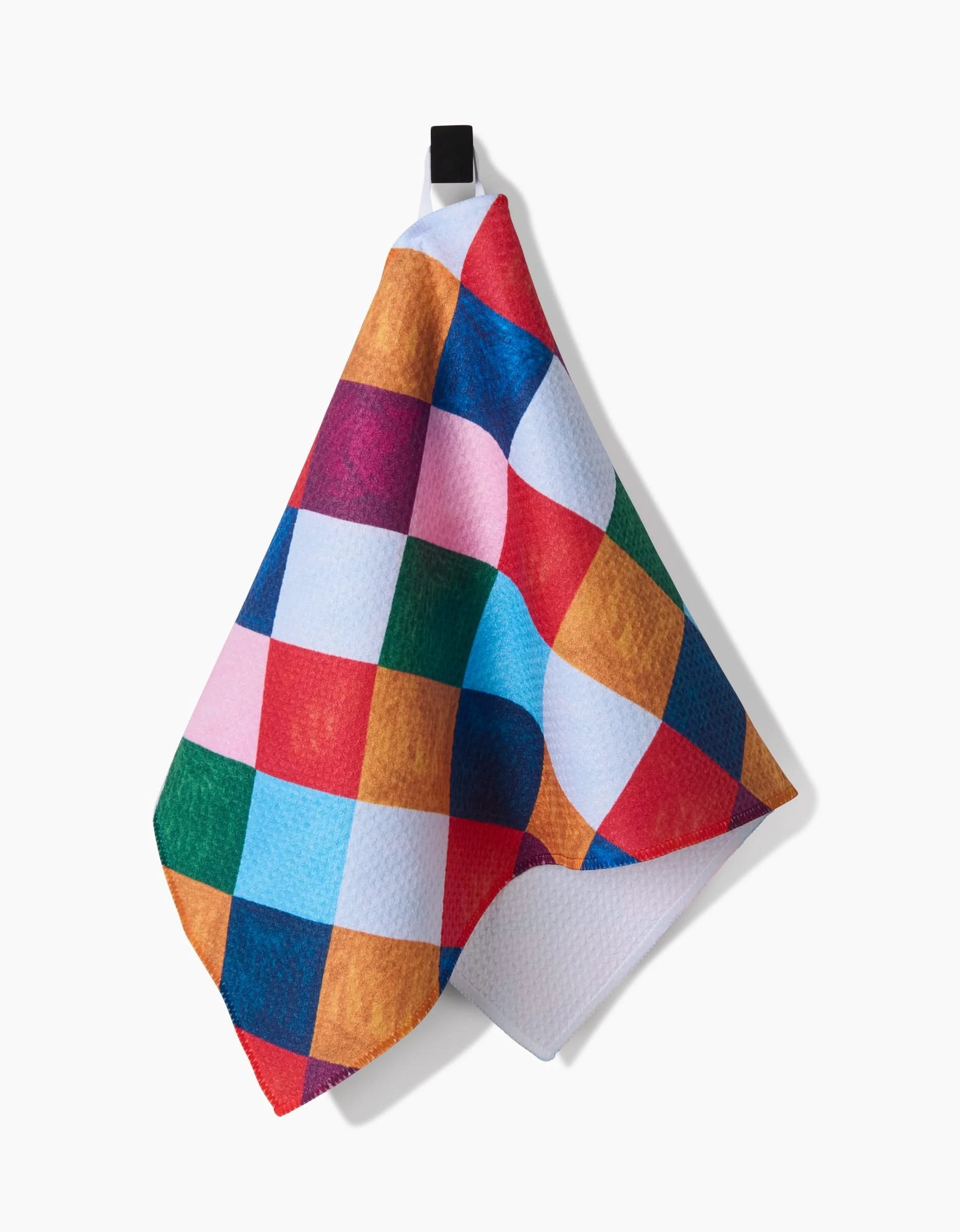 The Holiday Harlequin by Daria Solak is a colorful, ultra-absorbent towel with a red, blue, green, yellow, pink, and white checkered pattern—ideal as a vibrant bar towel or recycled kitchen towel.