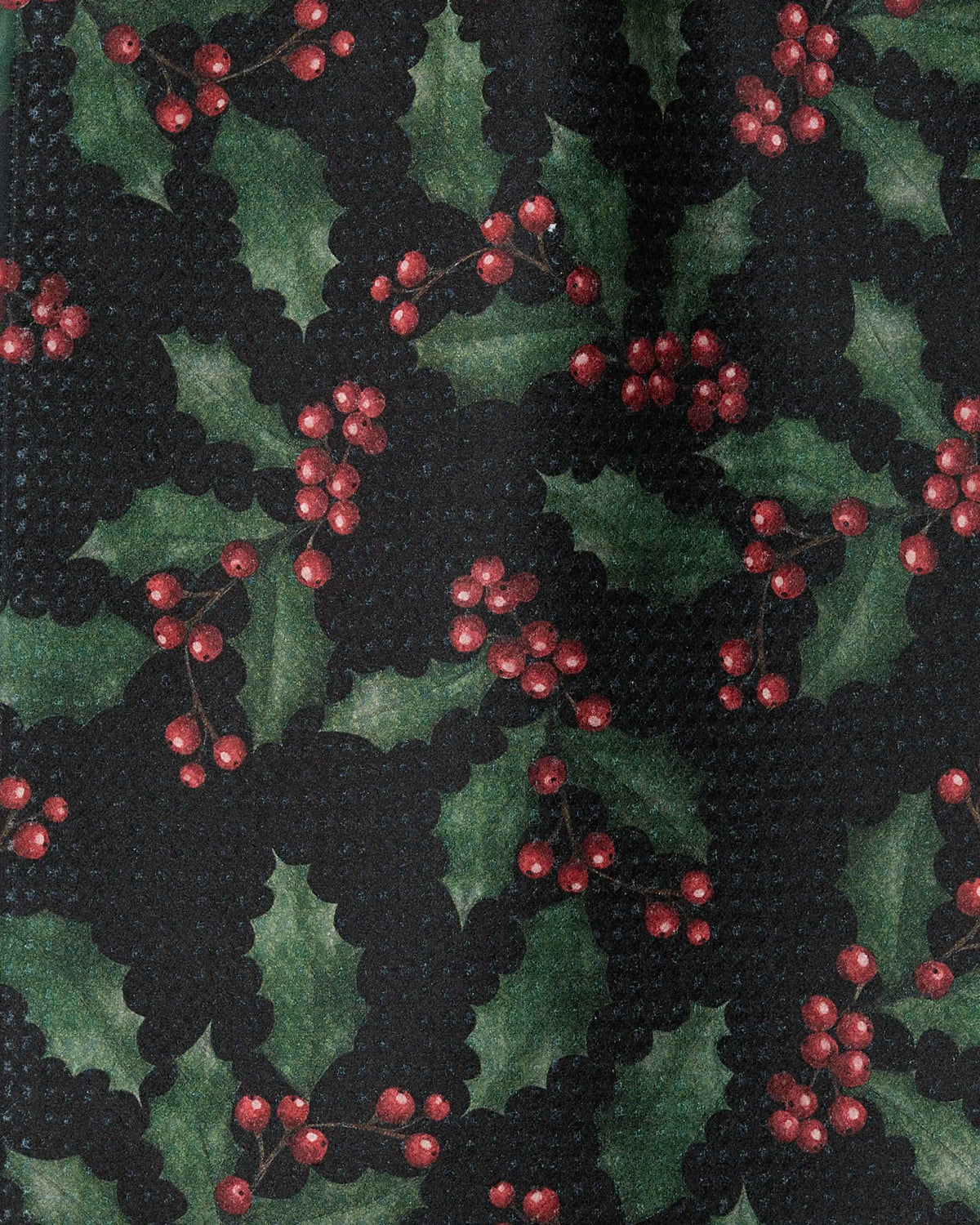 Holly Night by Geometry features a repeating pattern of green holly leaves and clusters of red berries on a dark background, thoughtfully crafted with eco-friendly recycled materials.