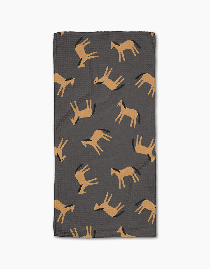 The Horses bar towel by Coit Creative features a dark gray rectangular design with a repeating pattern of stylized tan horses in various poses, made from eco-friendly Geoweave fabric using recycled materials.