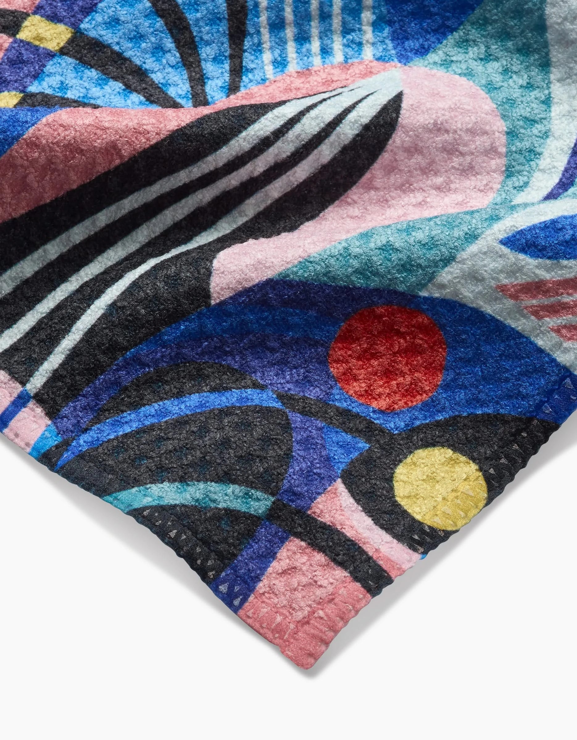 A close-up of Masha Volnova’s Imagined Realm Bar Towel, crafted from Geoweave fabric, featuring an abstract design with bold curved black lines, blue, pink, teal shapes, and red and yellow circles. Ultra-absorbent and stylish.