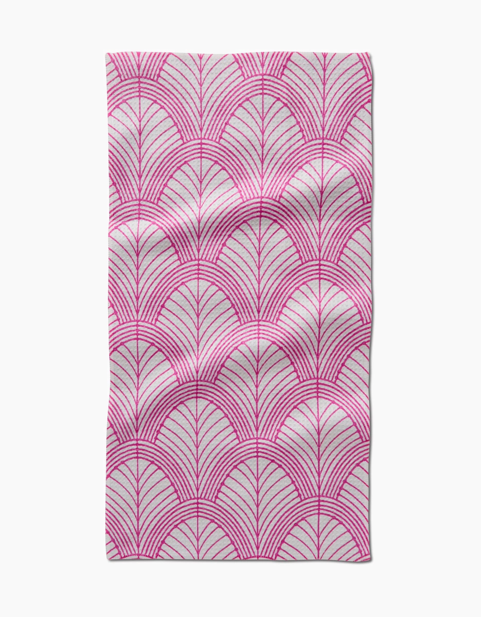 The Jaskin Bar Towel by Amy MacCready features rectangular Geoweave fabric with a pink fan-like geometric pattern on white, accented by thin radiating lines. Slight creases and folds are visible.