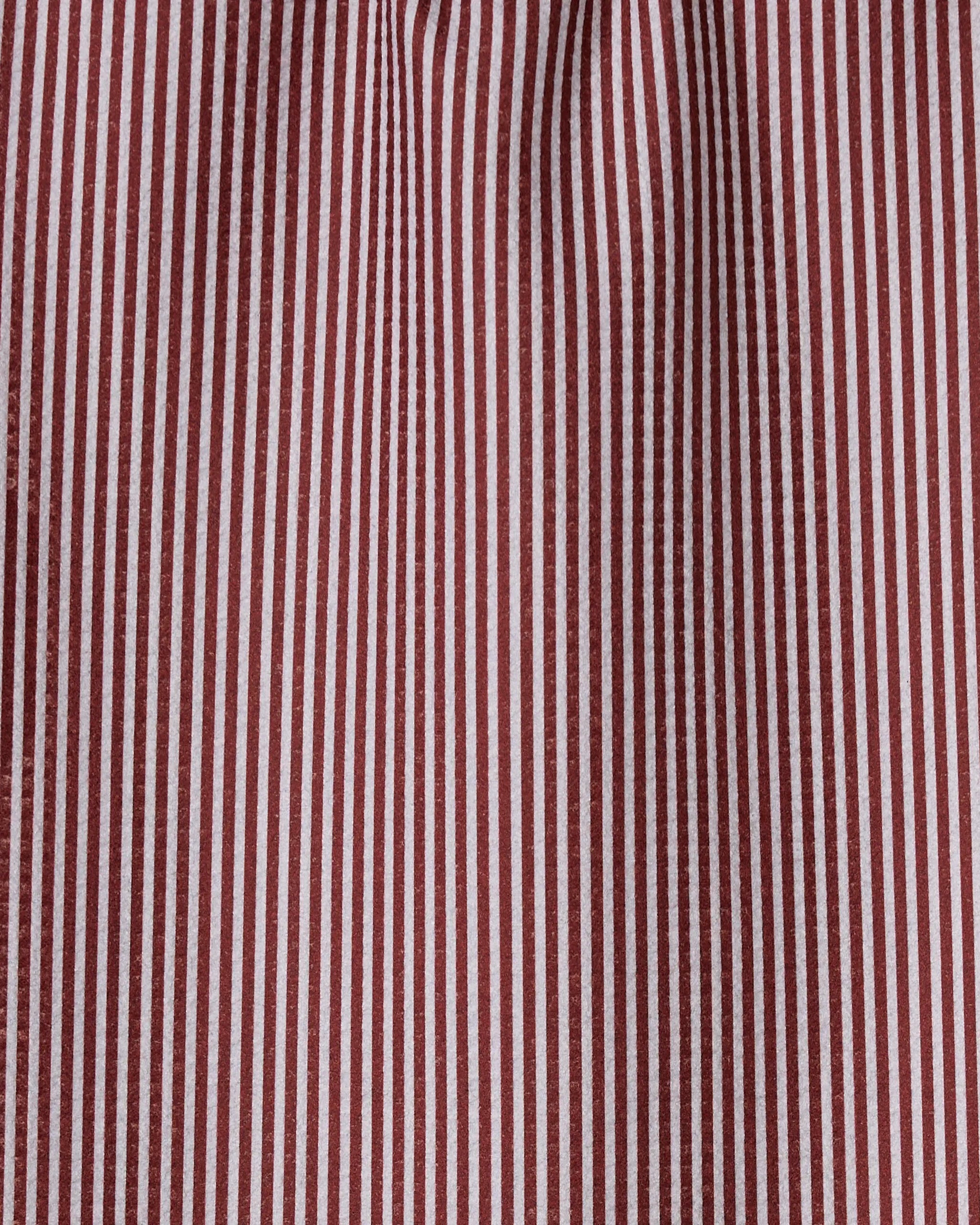 Close-up of the Kringle bar towel by Geometry, crafted from recycled materials. Quick-drying fabric features vertical maroon and white stripes with a regular, evenly spaced pattern and slight wrinkles.