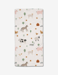 The Coit Creative Light Farm Animals baby blanket is made from ultra-absorbent Geoweave fabric and features a soft, earthy print of horses, cows, pigs, chickens, ducks, trees, flowers, barns, and ponds.