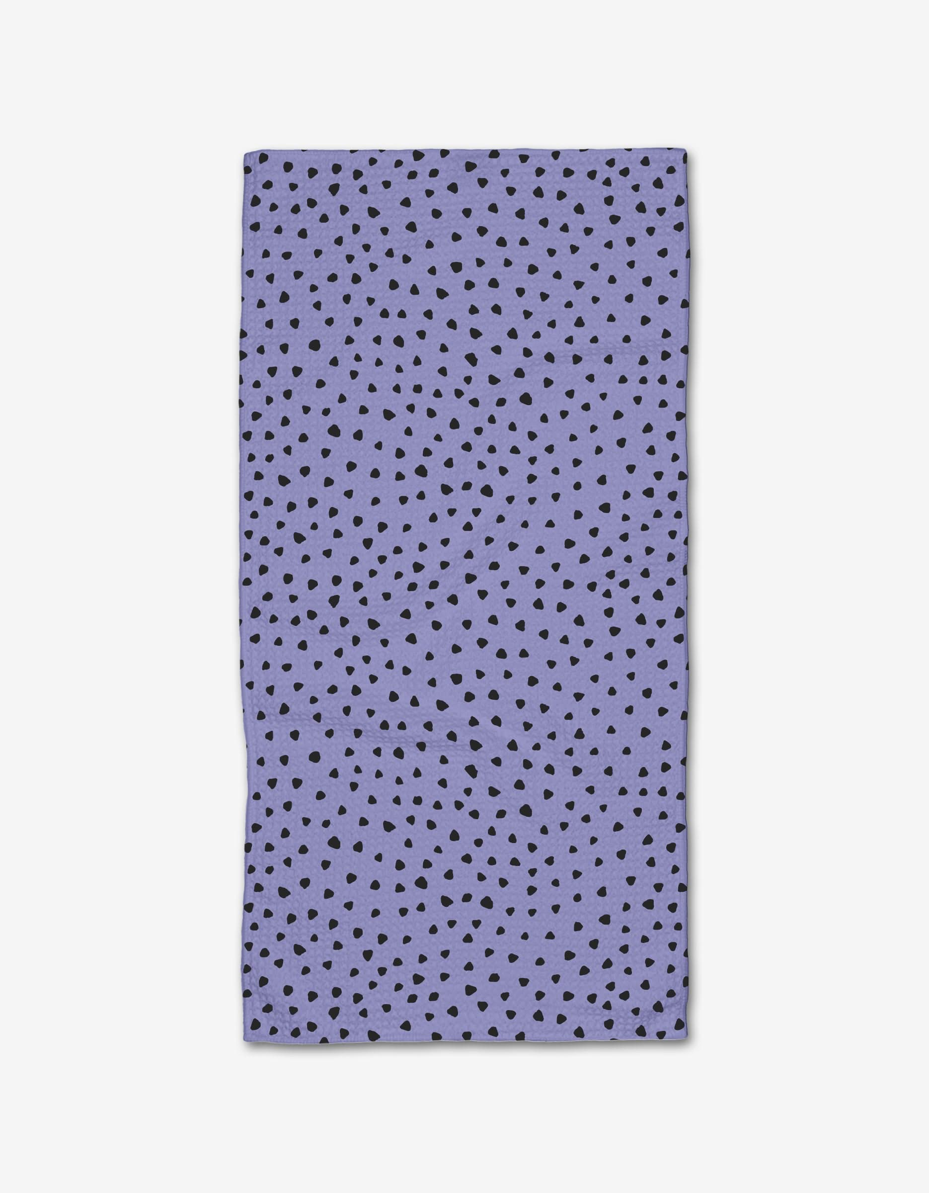 The Lilac Speckle by Hufton Studio is a rectangular, purple cloth napkin made from recycled materials, featuring an all-over pattern of small, irregular black dots.