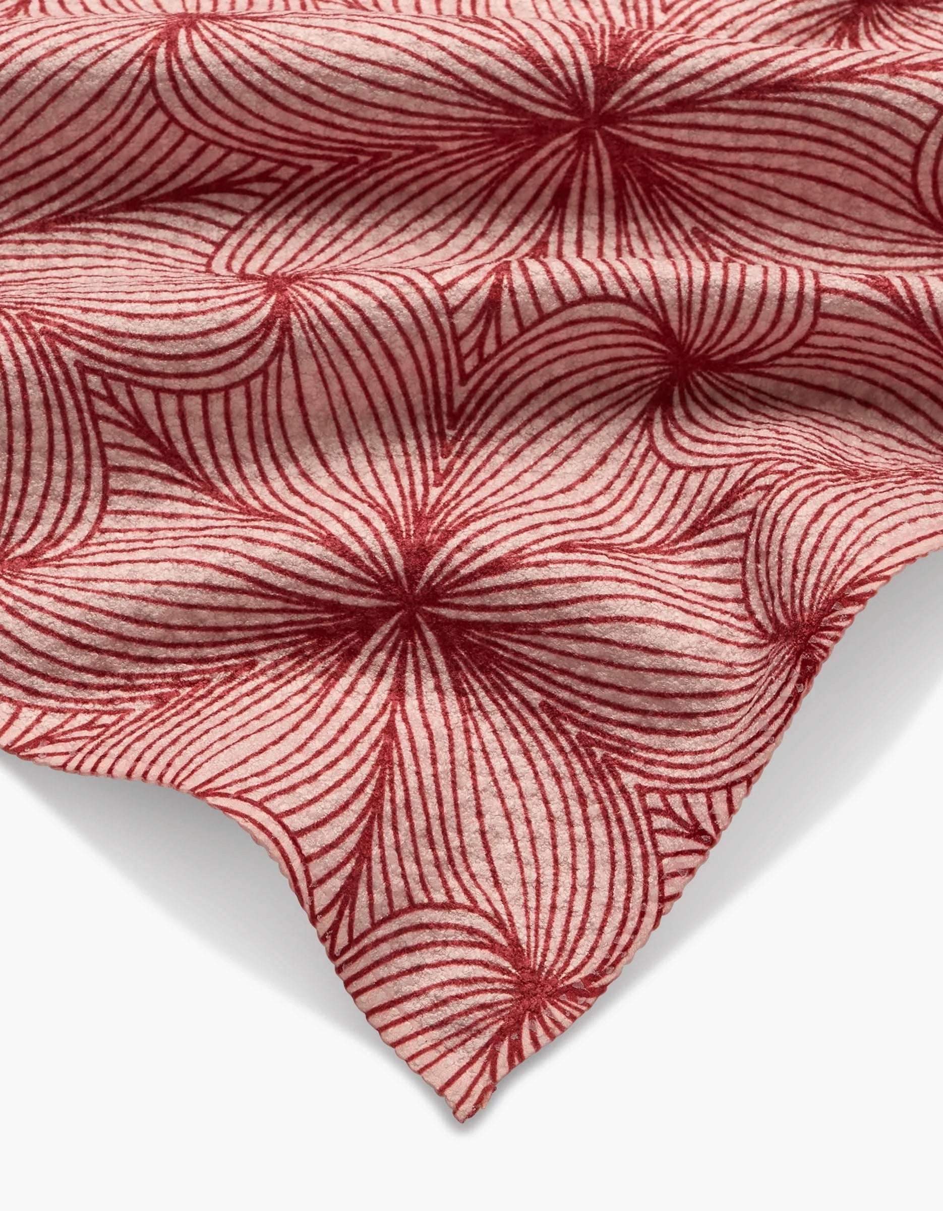 Lined by Marta Harvey: A Geoweave fabric with a red, flower-like pattern of curved lines radiating from multiple centers on a cream background, creating an intricate and textured look.