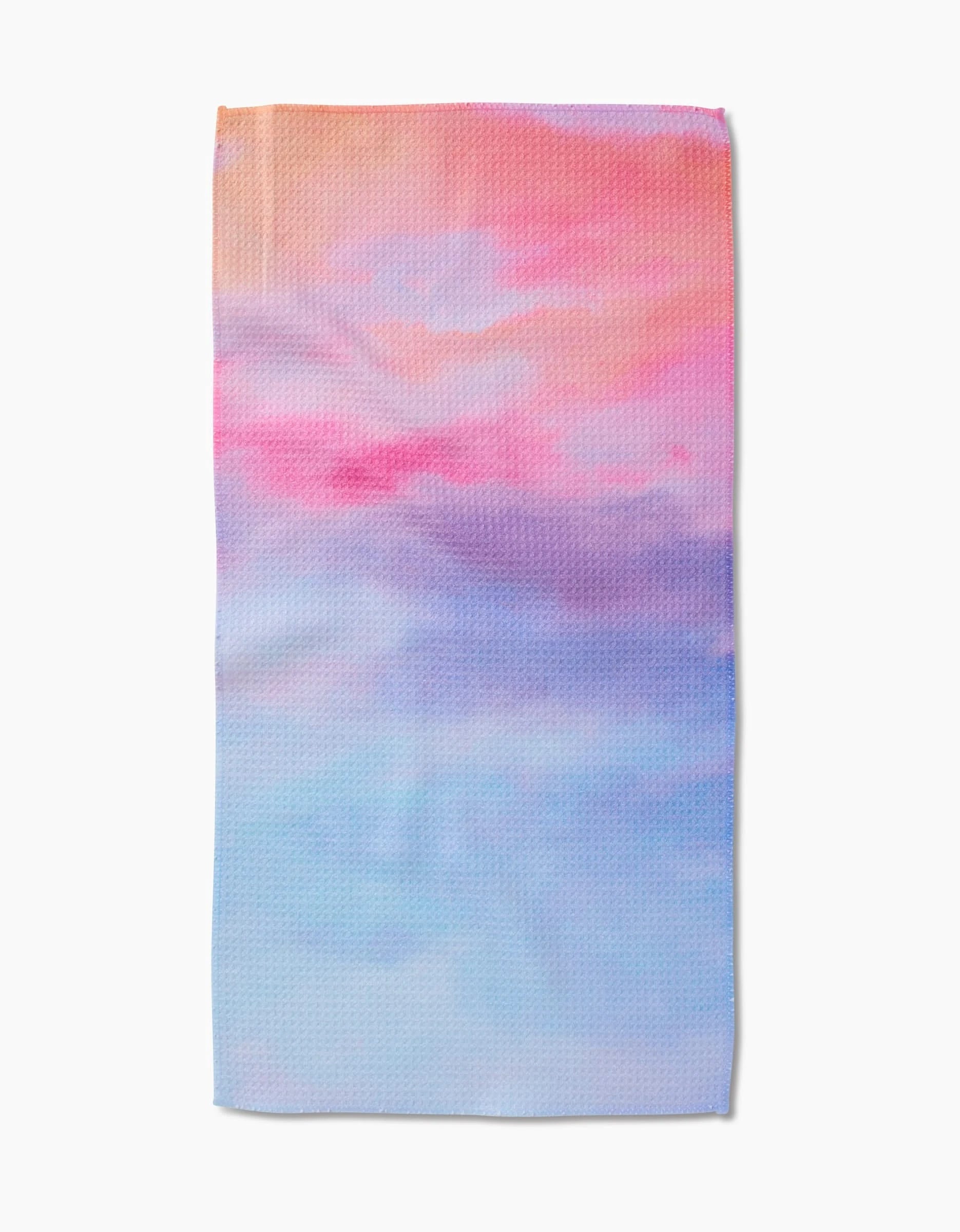 The Magic In The Sky Bar Towel by Stefanie Bales features a dreamy pastel gradient of pink, peach, lavender, and blue on Geoweave™ fabric, shown flat against a white background.