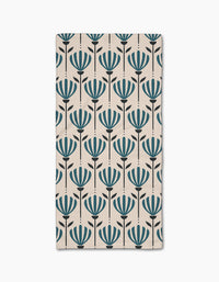 The Martine rug by Amy MacCready is a rectangular beige piece with evenly spaced rows of stylized blue flowers and black stems, crafted from recycled materials for an eco-friendly touch.