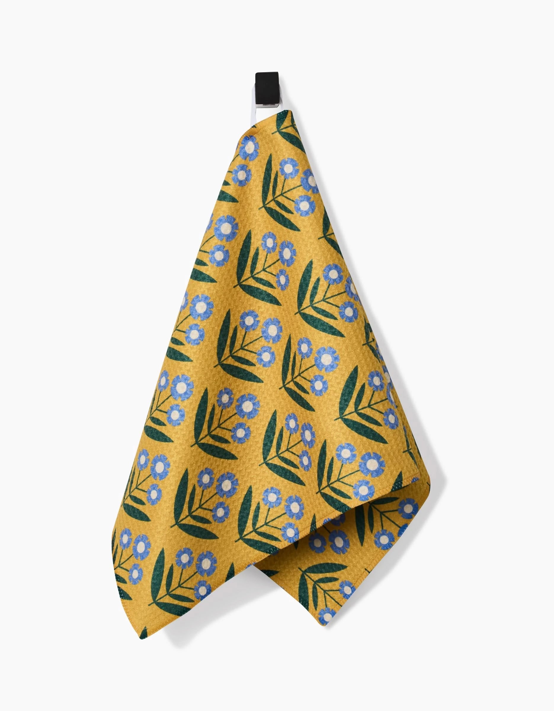 The Mayday Bar Towel by Megan Kampa features a yellow design with blue flowers and green leaves, hangs from a black loop against a white background, and is crafted from recycled materials.