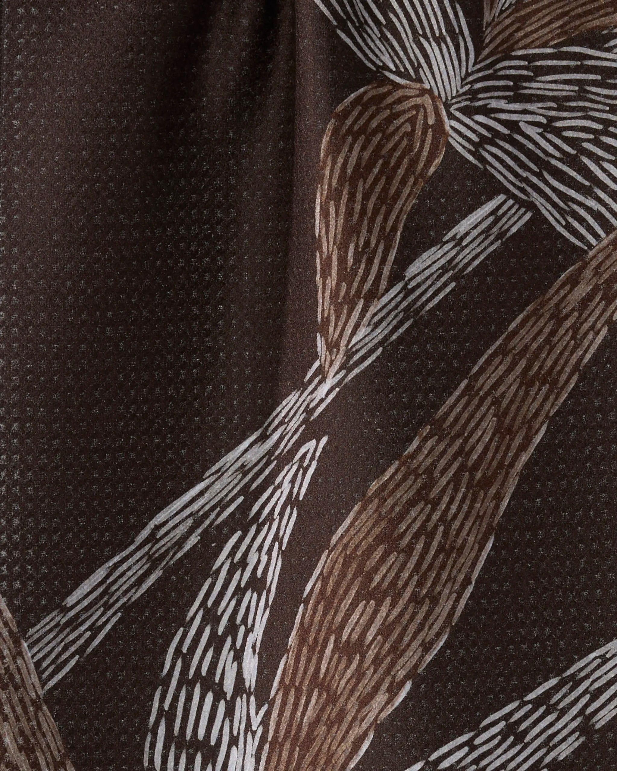 Close-up of Geometry’s "Midnight Wildflower" bar towel, featuring quick-drying fabric with an abstract botanical pattern in light brown and white on a brown background, evoking leaves with brushstroke-like texture.