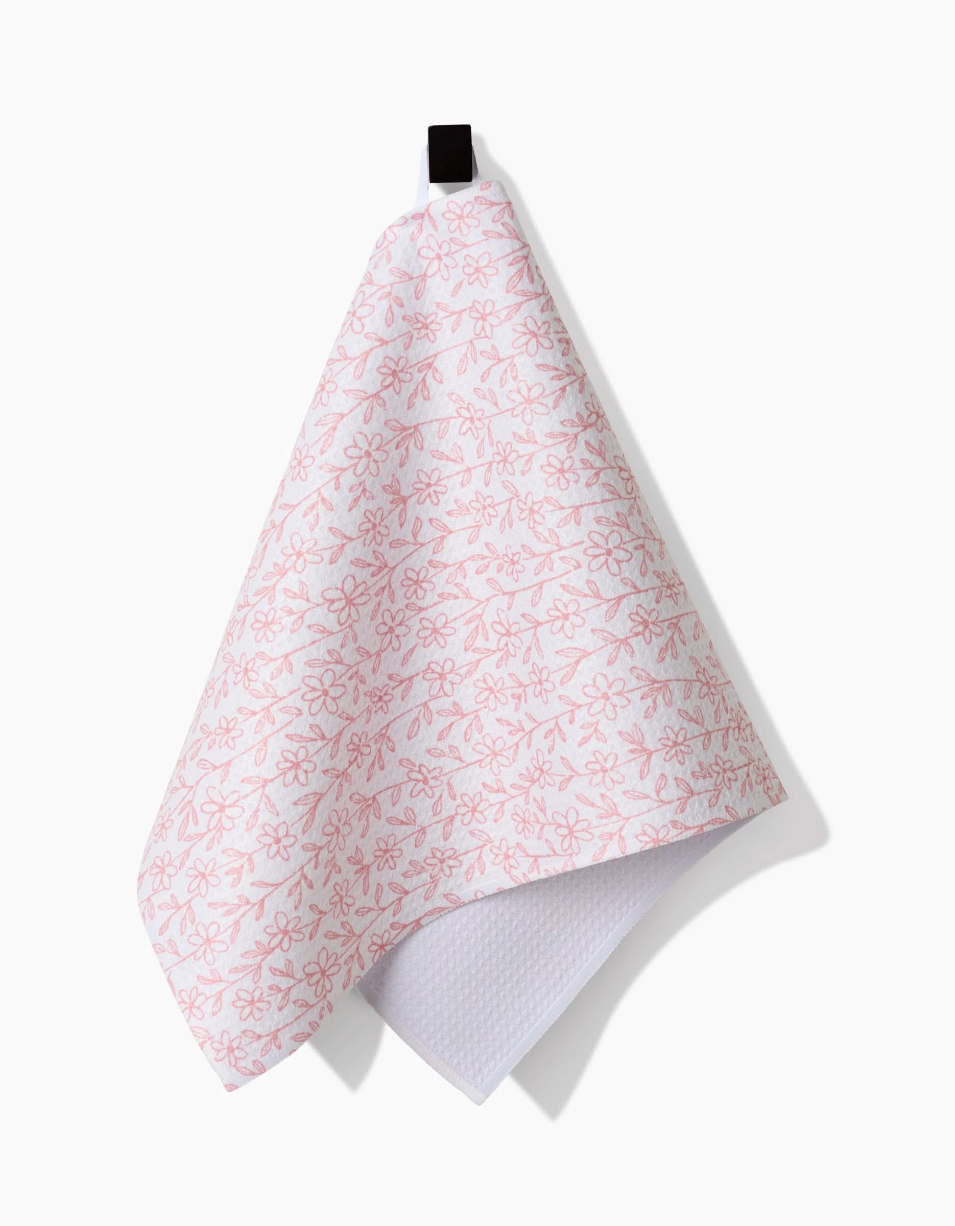 The Minimalist Blush bar towel by Teri the Butter features a pink floral design on white ultra-absorbent Geoweave fabric and hangs from a black loop, shown against a plain white background.