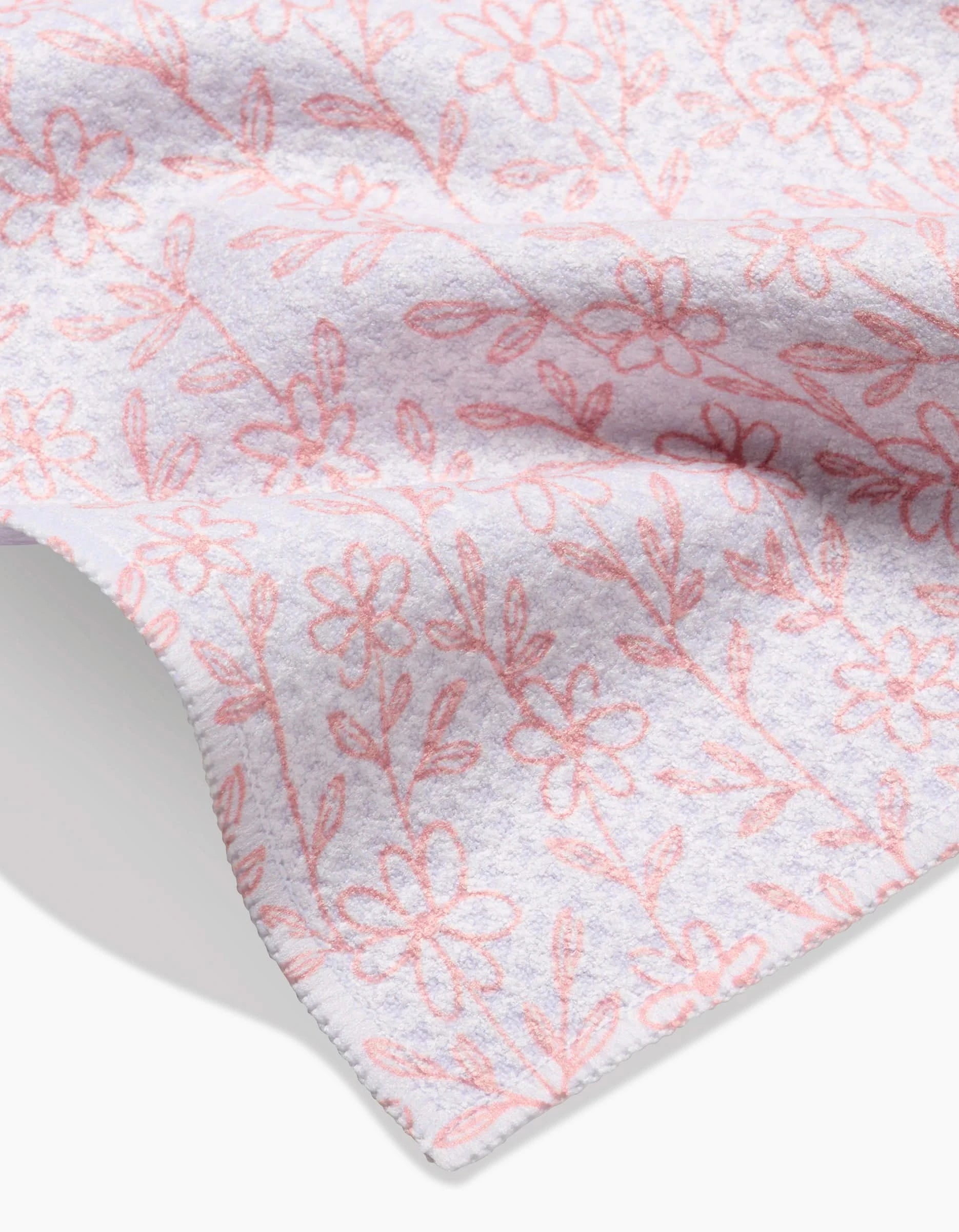 The Minimalist Blush Bar Towel by Teri the Butter features ultra-absorbent Geoweave fabric, a smooth stitched edge, and a light design of pink outlined flowers and leaves.