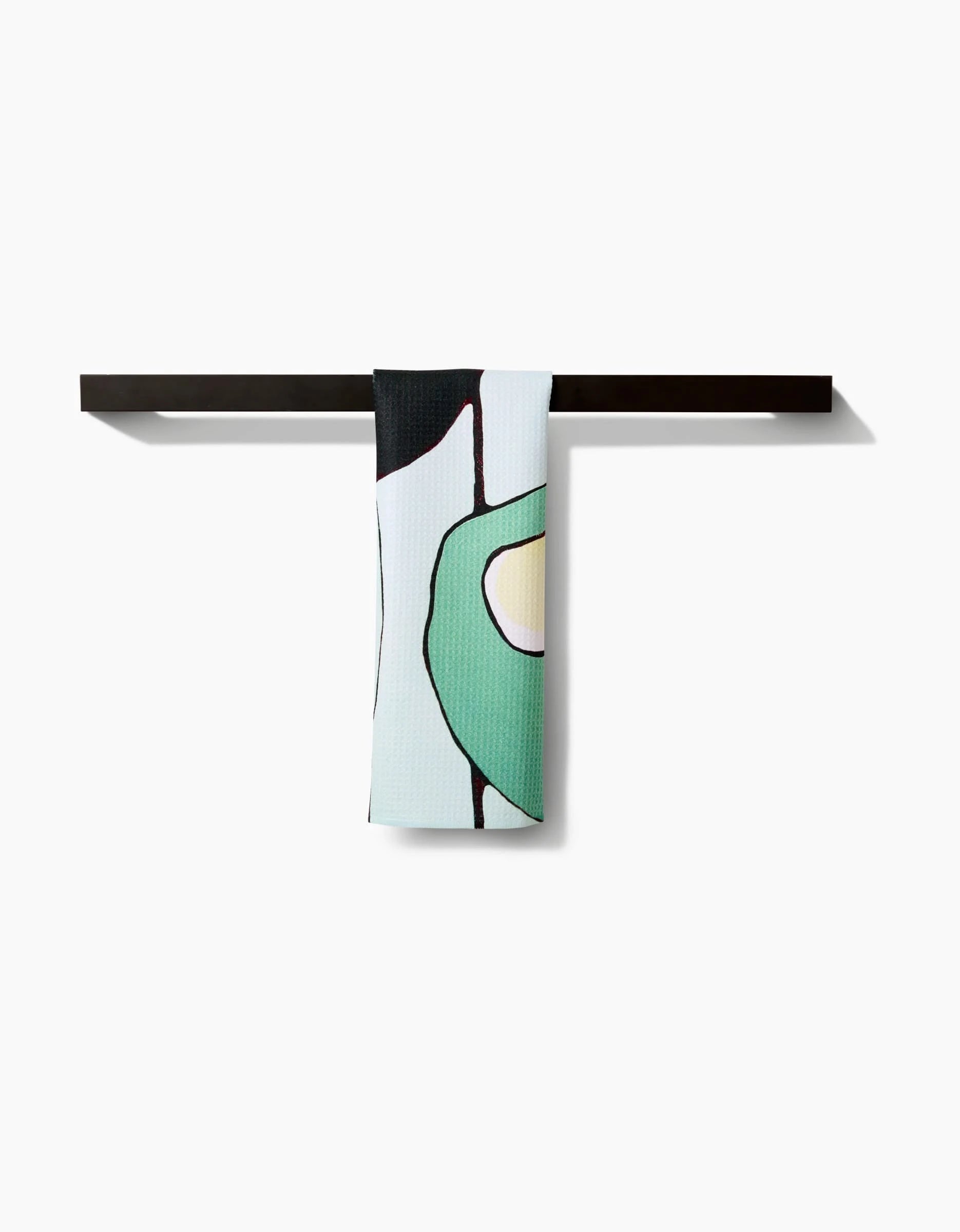 The Rachel Austin Modern Poppy bar towel, made from premium Geoweave fabric, showcases a minimalist abstract green and yellow design draped over a sleek black bar on a white background.