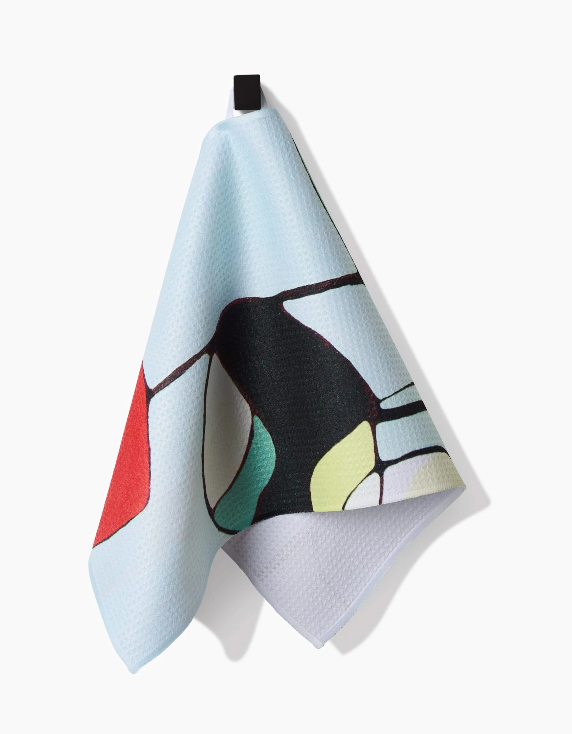 The Modern Poppy bar towel by Rachel Austin features Geoweave fabric and an abstract design with red, green, yellow, and black shapes. It hangs from a black loop against a white background.