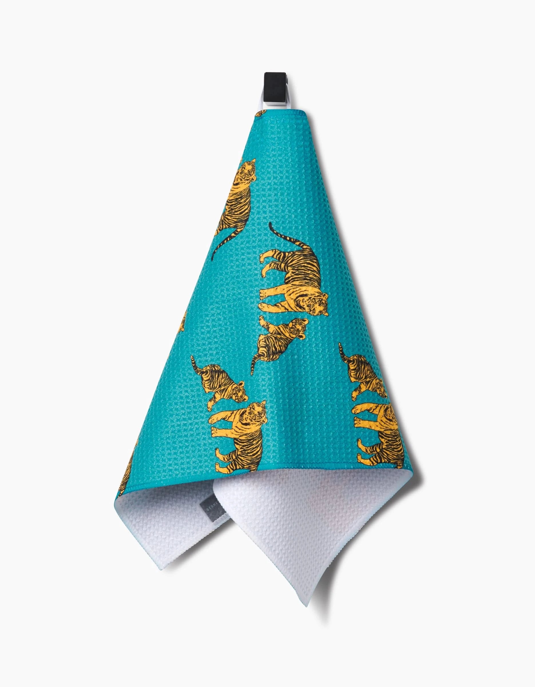 The Mommy and Me bar towel by Sarah Holden features a turquoise textured design with yellow and black tigers, a black hanging loop, and a white absorbent inner side, crafted from Geoweave fabric for superior functionality.