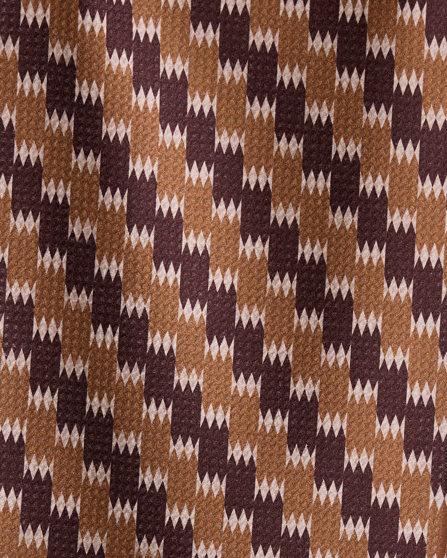 Mountain Song by Geometry is a brown fabric made from recycled materials, featuring dark brown and tan rectangles with small white diamond shapes for a textured, dynamic look.