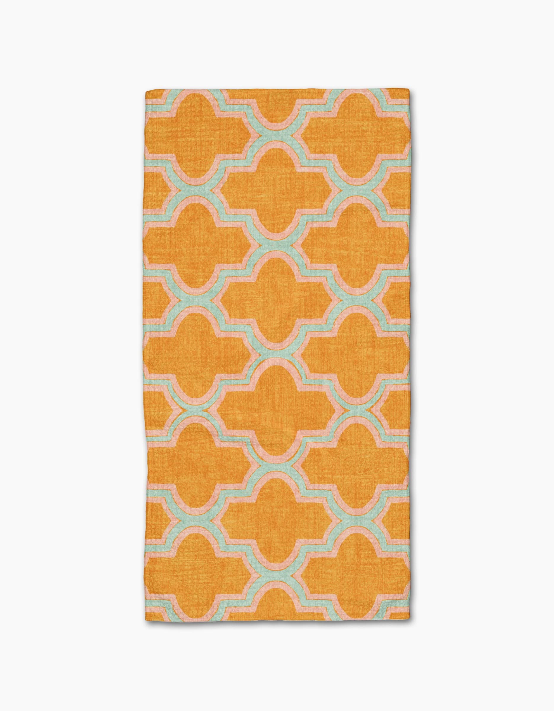 The Mustard Ogee by Pascale Dilger is a rectangular, ultra-absorbent towel featuring a bold orange geometric pattern with interconnected shapes outlined in light blue and white on a plain white background.