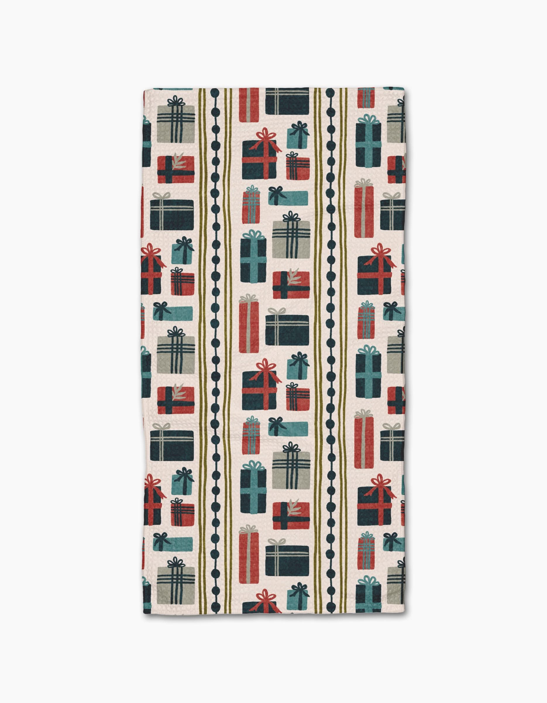 The Olaf napkin by Amy MacCready is a rectangular cloth made from recycled materials, featuring red, green, and blue gift boxes with bows on a cream background. Vertical scalloped lines separate the festive pattern.