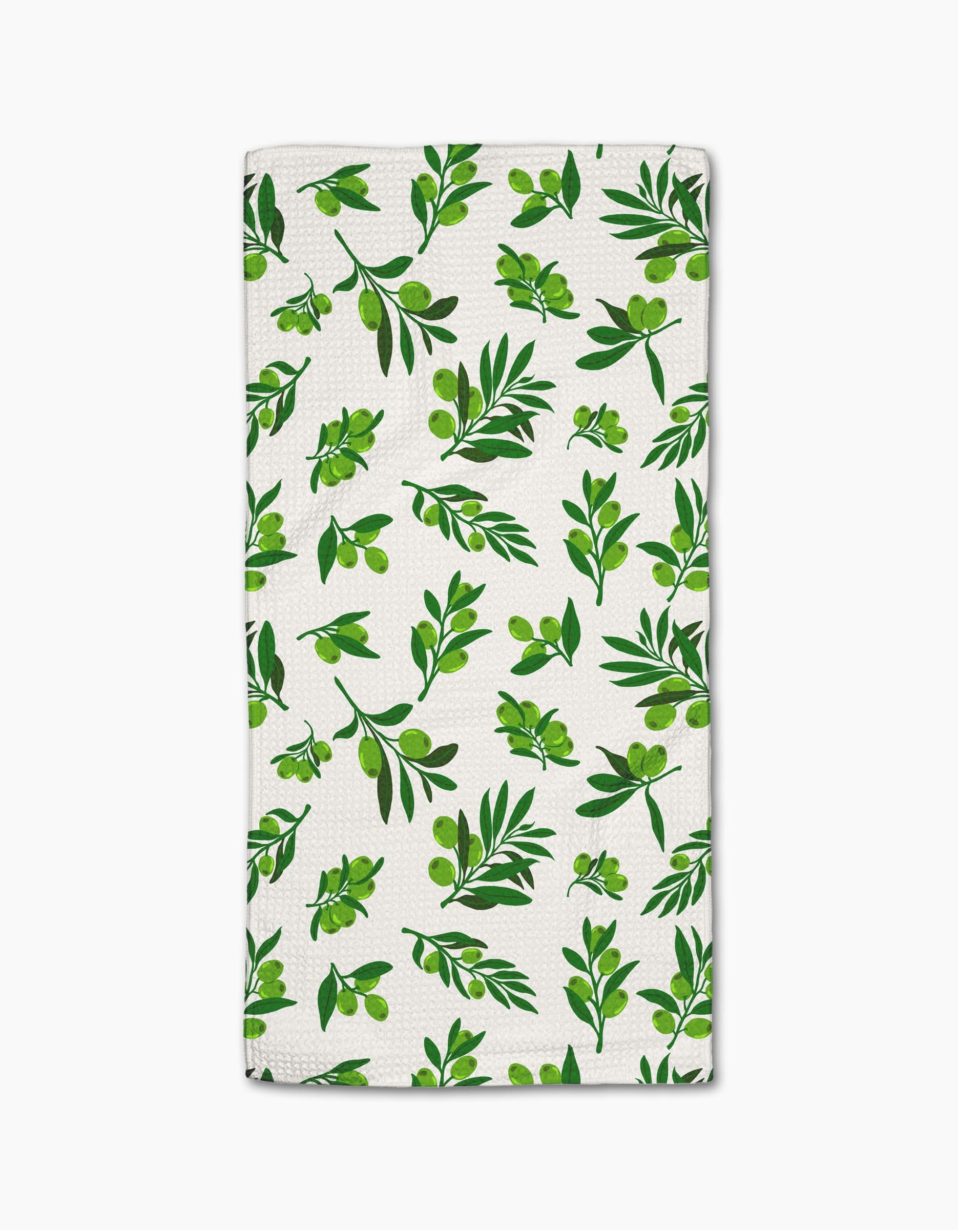 The Olive Grove towel by Geometry features ultra-absorbent white fabric with a stylish repeating green olive branch pattern—perfect as a chic bar towel for your kitchen.