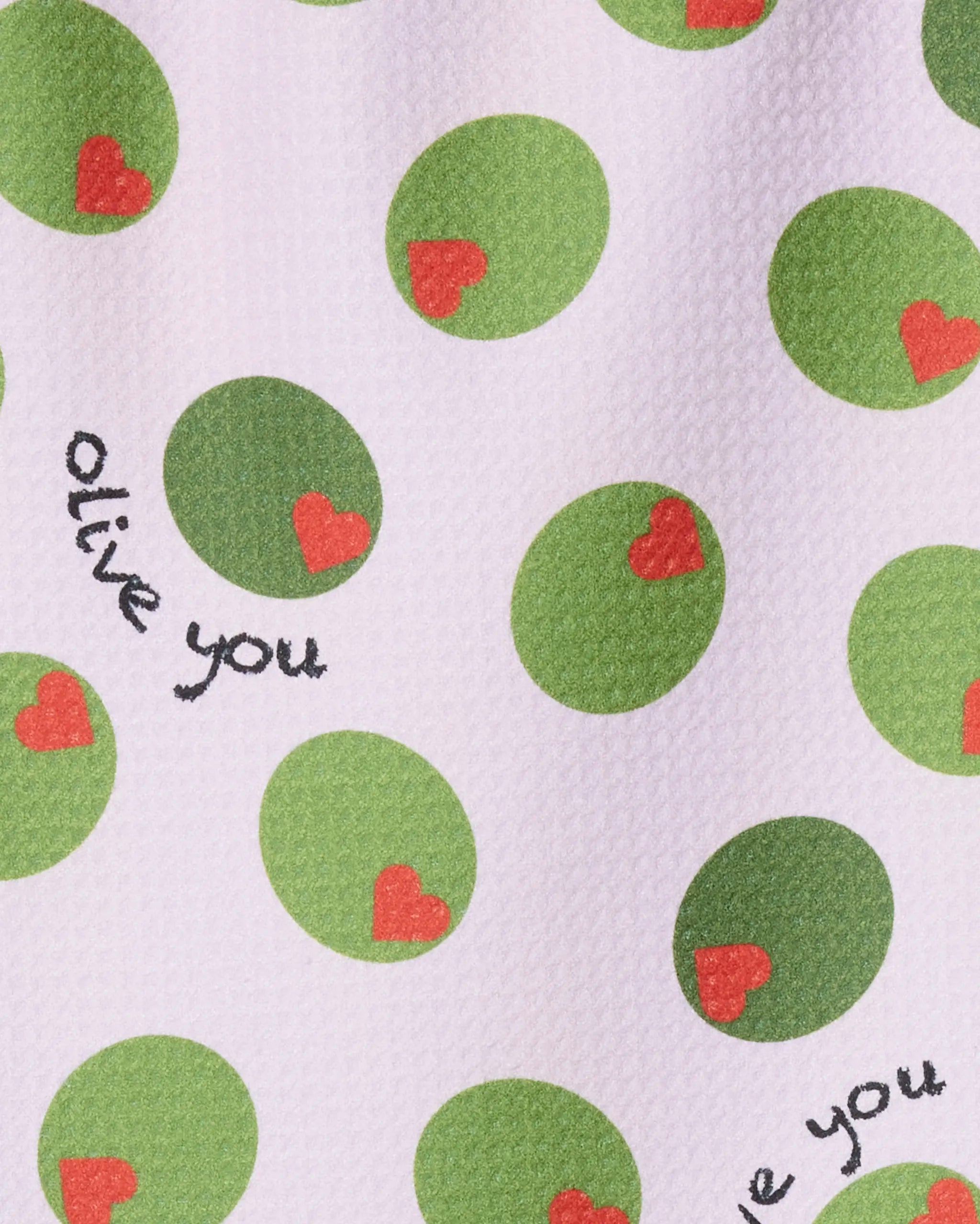 The Geometry "Olive You" towel features green olives with red heart-shaped pimentos and the playful phrase "olive you" on a crisp white, ultra-absorbent fabric.