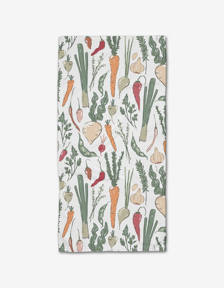 The Organic Vegetable kitchen bar towel by Hufton Studio features hand-drawn veggies—carrots, leeks, turnips, garlic, radishes, and peas—on a white background and is made with absorbent Geoweave fabric.