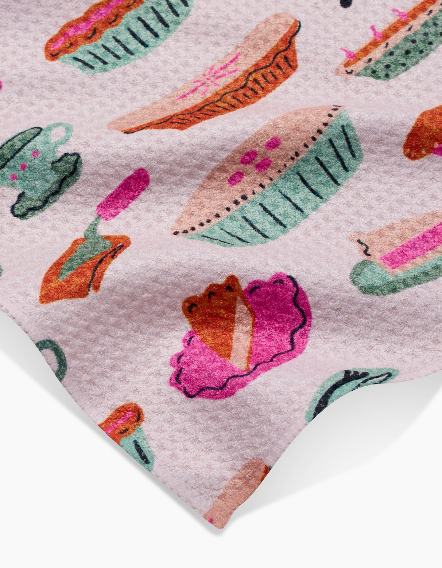 The Orla Bar Towel by Amy MacCready features a textured pink design with colorful pie, teacup, fork, and pie slice illustrations in green, pink, purple, and orange—all crafted from durable Geoweave fabric.