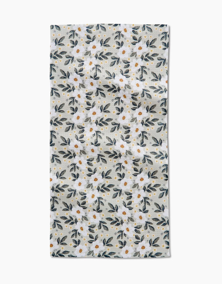 The Painted Spring Flowers Bar Towel by Teri the Butter features a white, rectangular design with small white flowers, yellow centers, and blue-green leaves on a light grey background. Made from durable Geoweave fabric.