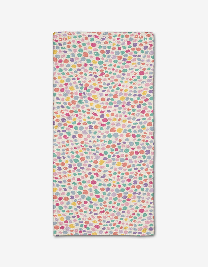 The Pastel Petal bar towel by Rebecca Bobko features pink, yellow, red, green, and purple polka dots on a white background. Made from eco-friendly Geoweave fabric.