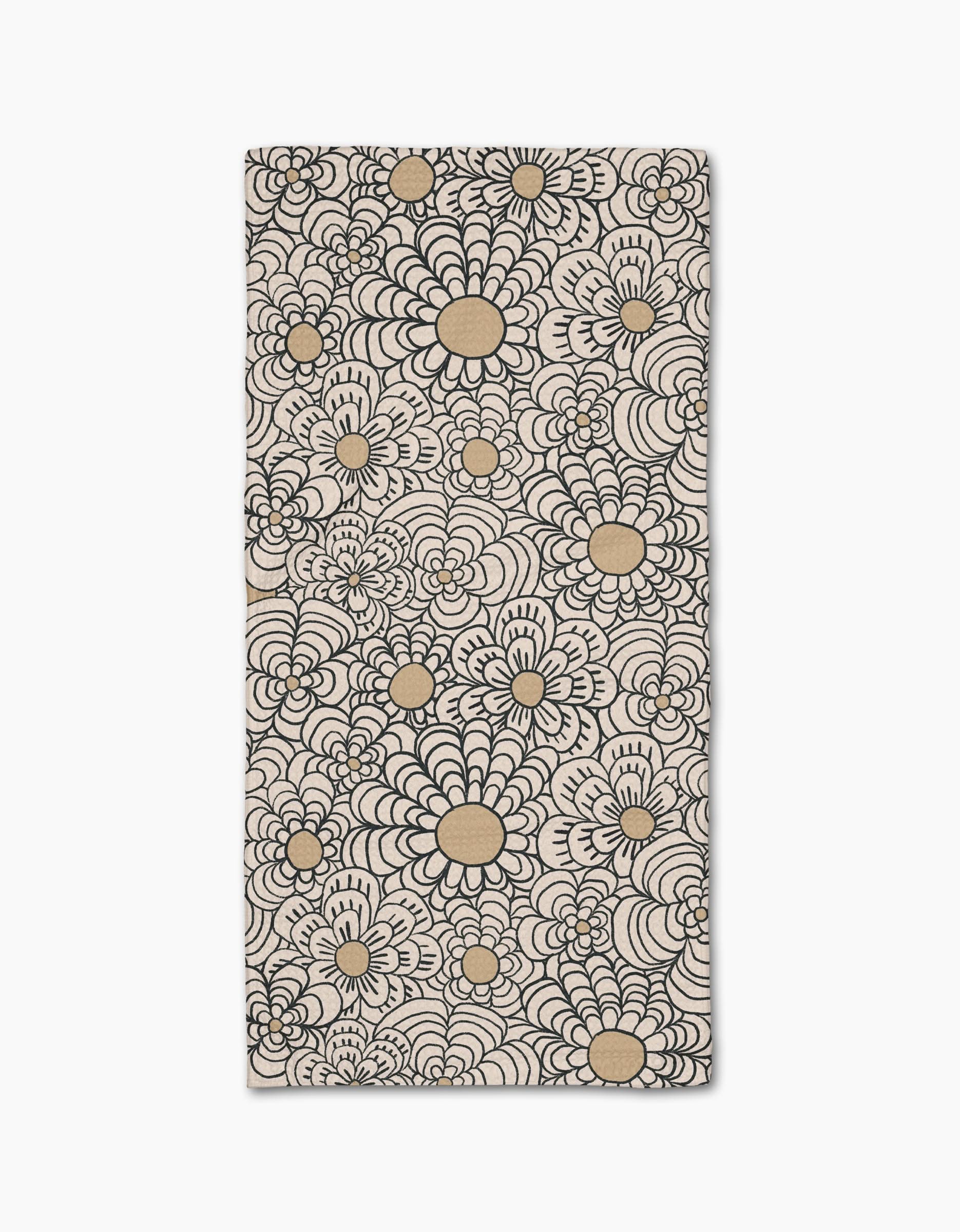 The Paulette bar towel by Amy MacCready showcases a bold black and tan floral pattern with large, stylized flower shapes on ultra-absorbent beige Geoweave fabric covering the entire rectangular surface.