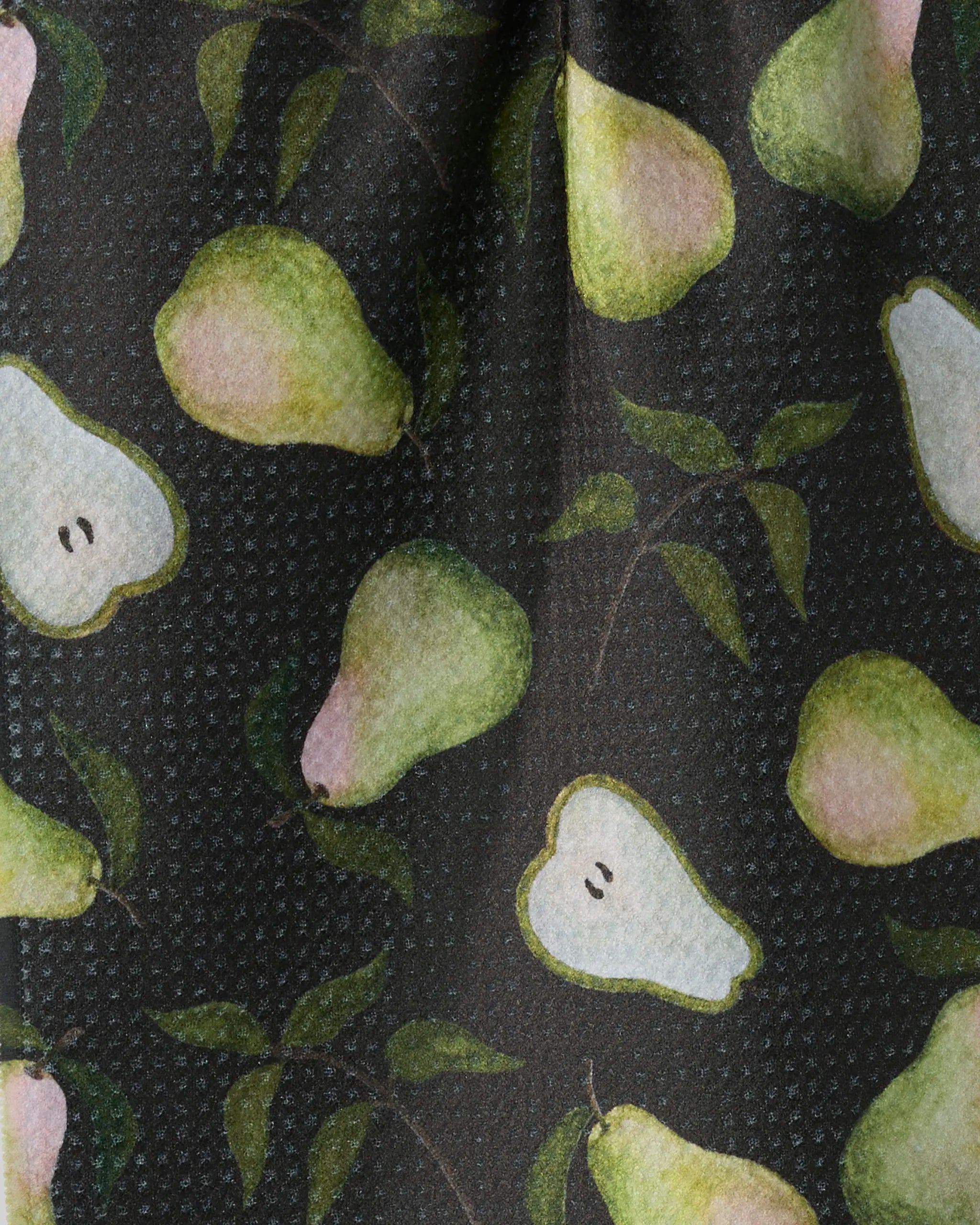 The Pearwood bar towel by Geometry features green and yellow pears—whole and sliced with seeds—on a dark patterned background. Made from recycled materials.