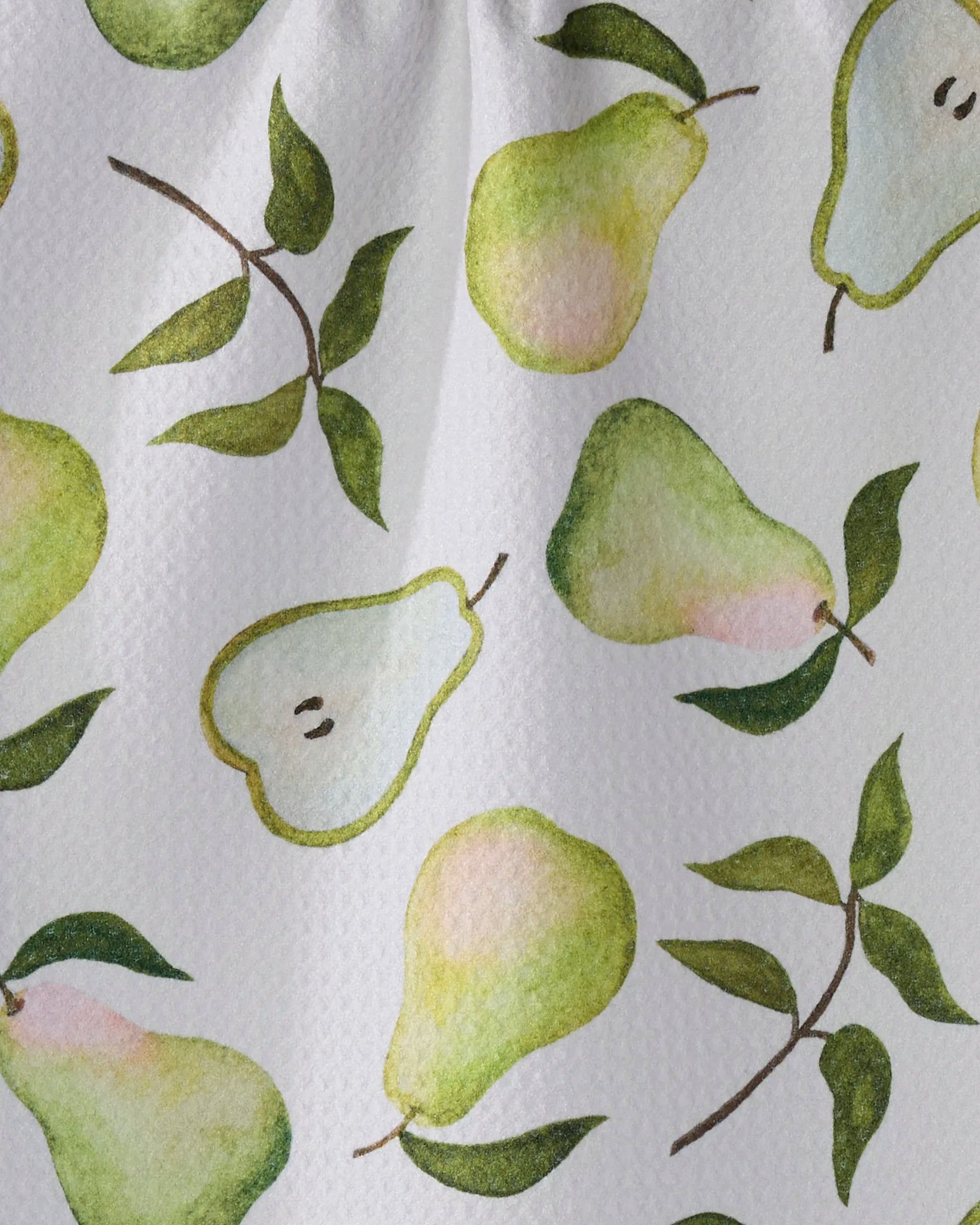 The Geometry Pearwood towel is ultra-absorbent and white, featuring a watercolor-style pattern of pears, pear slices, and green leaves in shades of green, yellow, and light pink—perfect as a stylish bar towel.