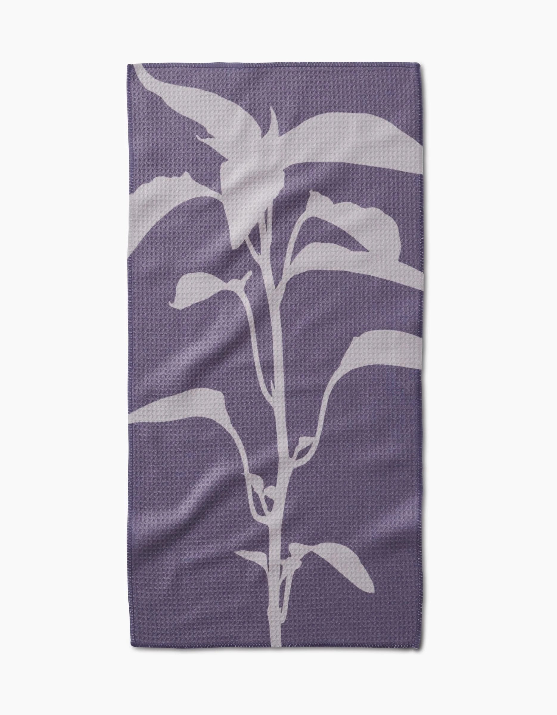 Pepper by PrintedPlant: a purple bar towel crafted from recycled materials, displaying a centered white, stylized plant silhouette with multiple leaves on a plain background.