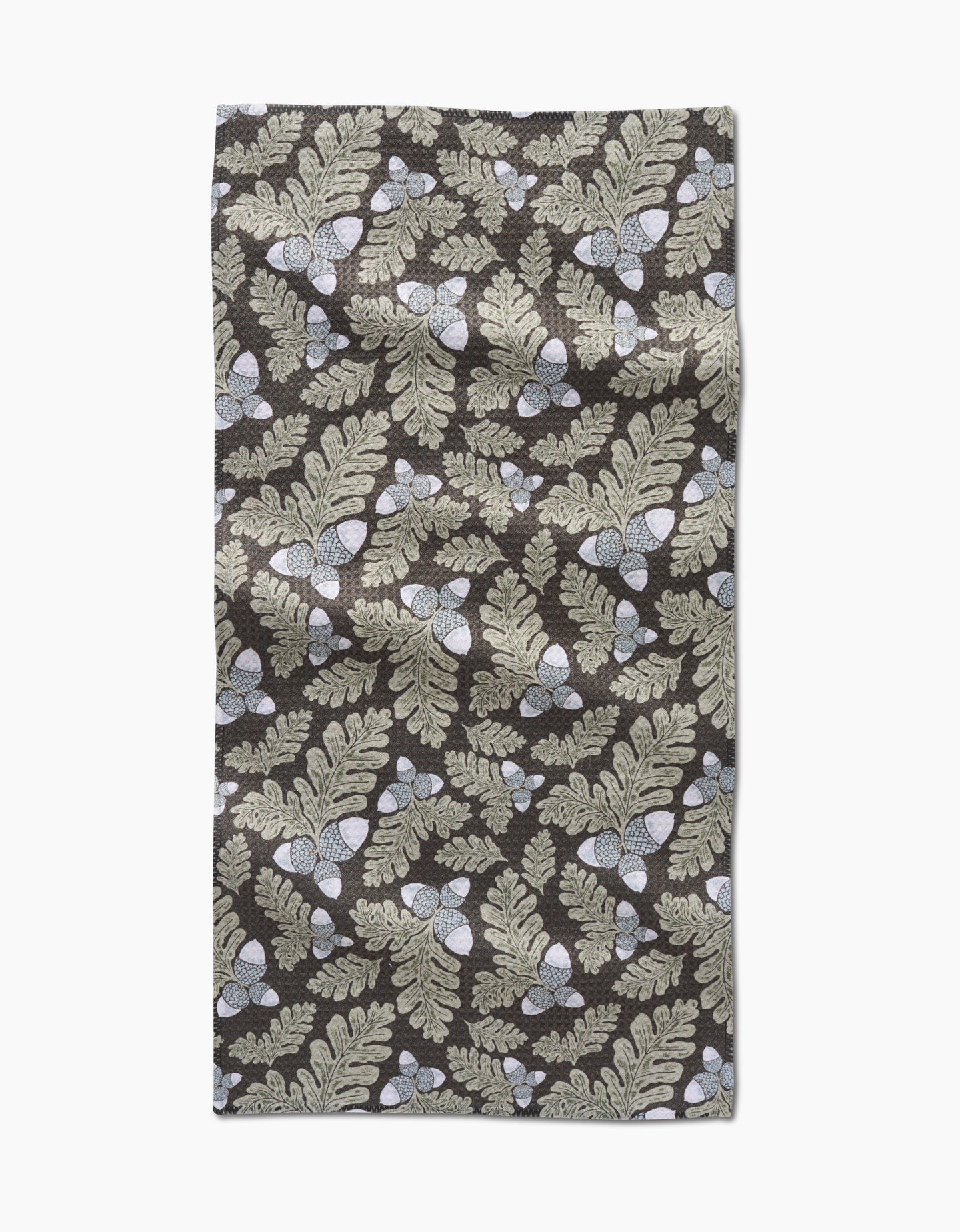 The Danelys Sidron Pinecone Patch is a rectangular, ultra-absorbent towel featuring beige oak leaves and acorns on a dark brown background, shown flat with some wrinkles visible.
