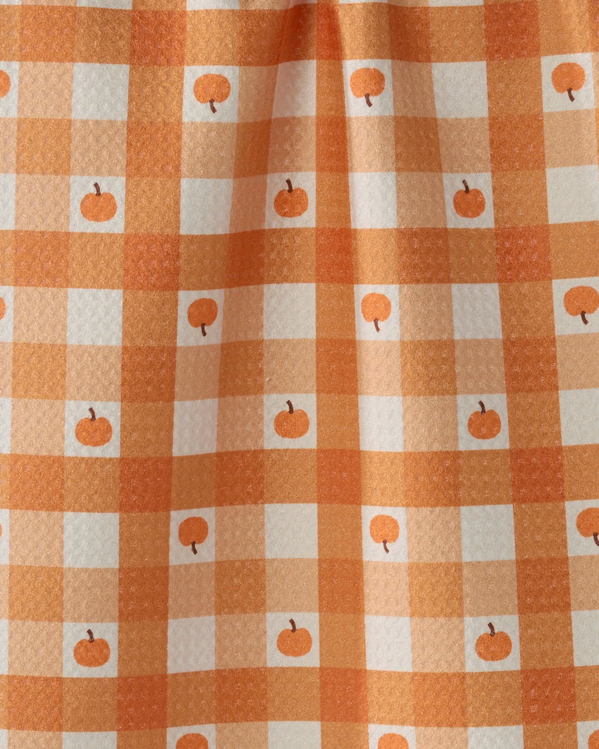 Pumpkin Check by Geometry features orange and white gingham with small pumpkins. This ultra-absorbent towel, with subtle folds and shadows, is perfect as a festive bar accessory.