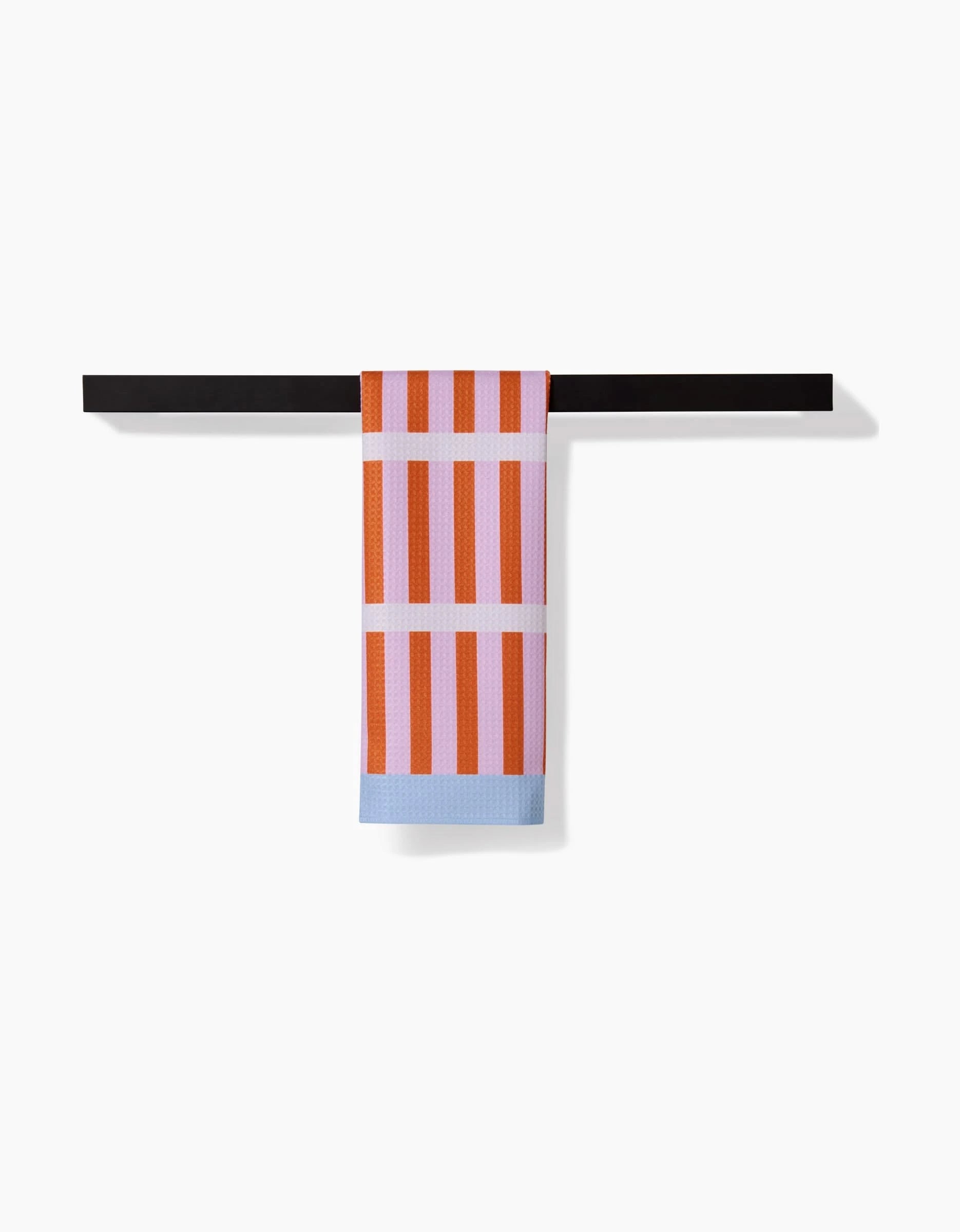 The Happy Hemera Red Glow bar towel, featuring vertical orange and pink stripes with a light blue border and made from recycled materials, hangs neatly over a black bar against a white background.