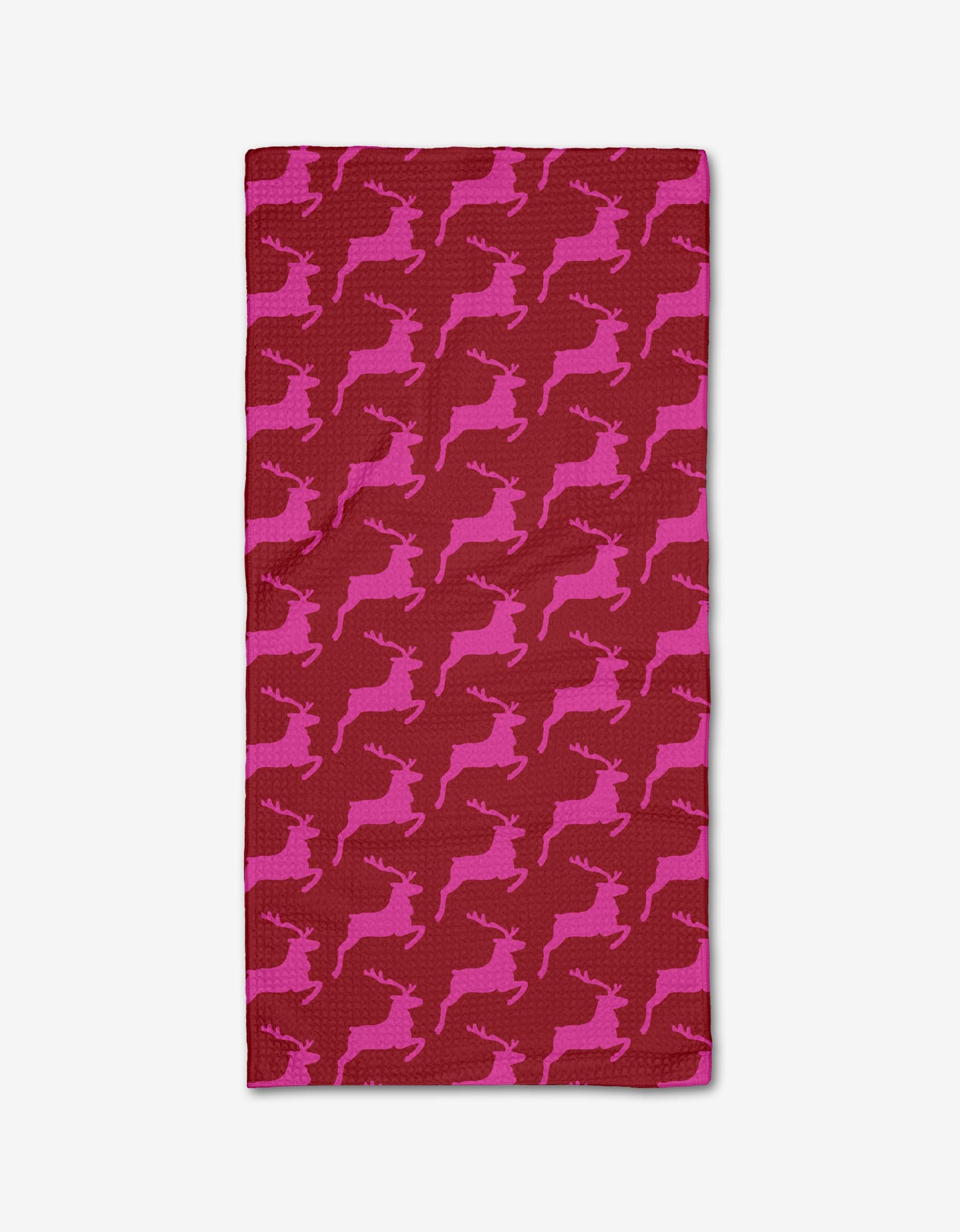 The Kayla Ann Red Reindeer bar towel showcases pink reindeer silhouettes on a red background and is crafted with soft, absorbent Geoweave fabric.