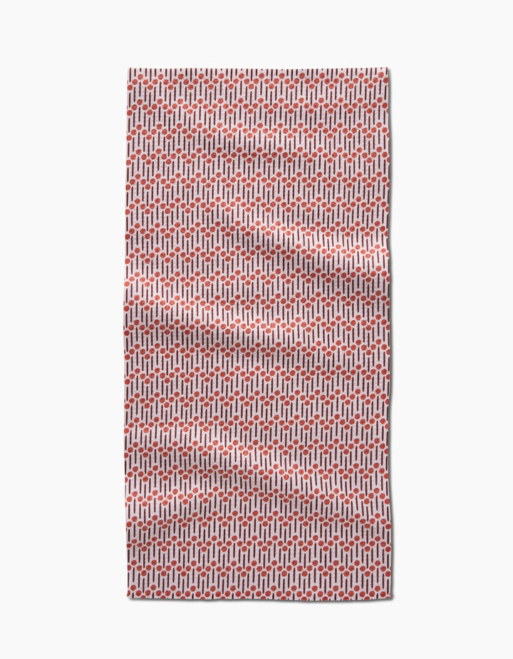 The Teri the Butter Retro Geo bar towel, made from Geoweave fabric, features a red and white repeating geometric pattern and is shown laid flat with slight wrinkles against a white background.