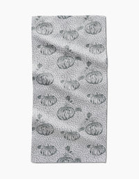 The Sage Pumpkin Field bar towel by Charlie Rowan Designs features hand-drawn pumpkins and dark gray dots evenly spaced across Geoweave fabric, creating a charming pattern on a slightly textured surface.
