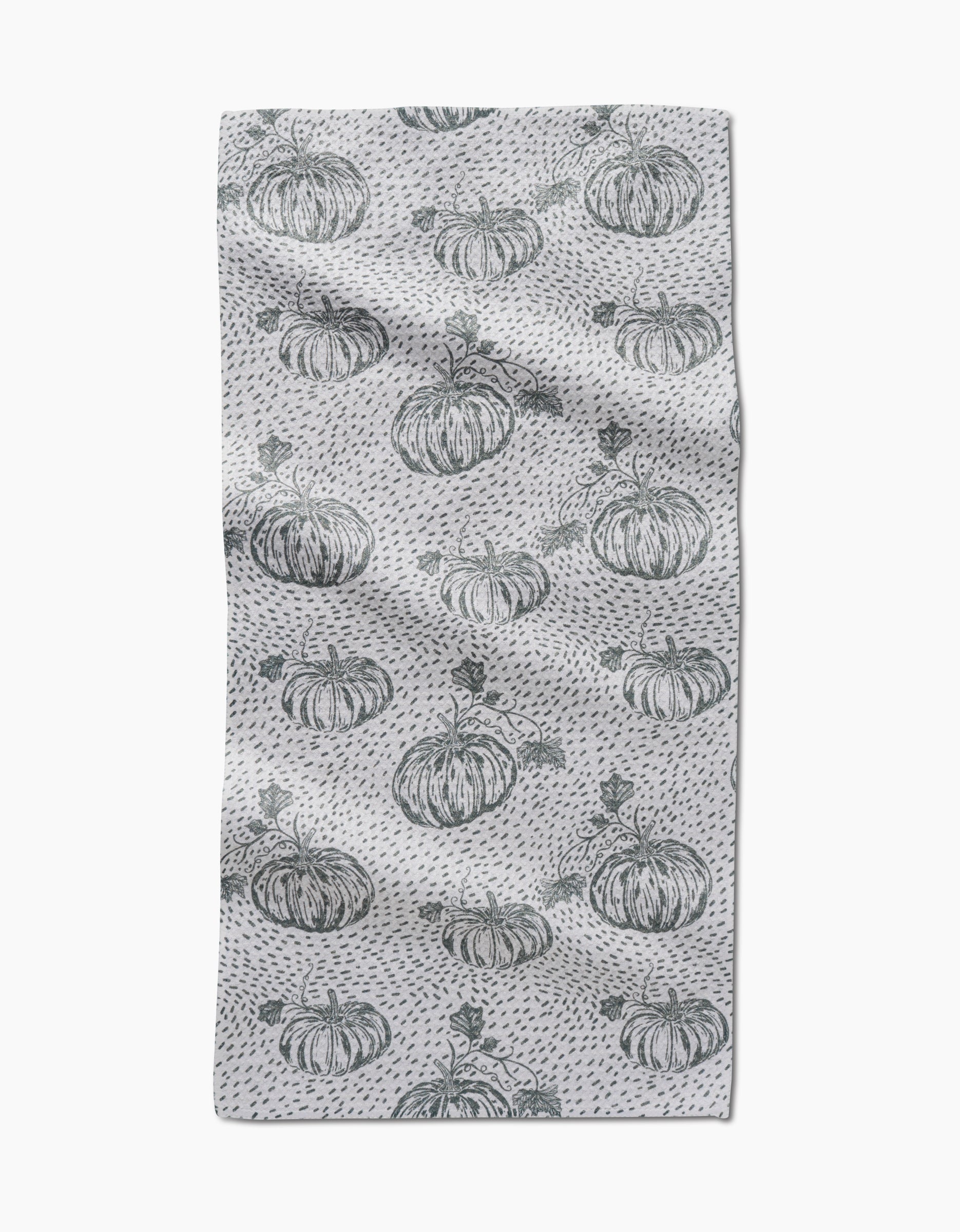 The Sage Pumpkin Field bar towel by Charlie Rowan Designs features hand-drawn pumpkins and dark gray dots evenly spaced across Geoweave fabric, creating a charming pattern on a slightly textured surface.