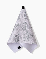 The Sage Pumpkin Field Bar Towel by Charlie Rowan Designs, crafted from Geoweave fabric, features gray pumpkin illustrations and dotted patterns. It hangs from a black loop against a white background.