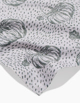 A light gray Sage Pumpkin Field bar towel by Charlie Rowan Designs features a black pumpkin and dotted line pattern. The fabric is slightly wrinkled, with the edge visible in the lower corner.