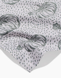 A light gray Sage Pumpkin Field bar towel by Charlie Rowan Designs features a black pumpkin and dotted line pattern. The fabric is slightly wrinkled, with the edge visible in the lower corner.