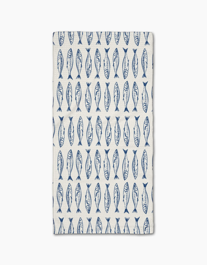 The Sardine Stripes Blue Bar Towel by Hufton Studio is white and rectangular, featuring neat rows of blue fish and crafted from durable Geoweave fabric.