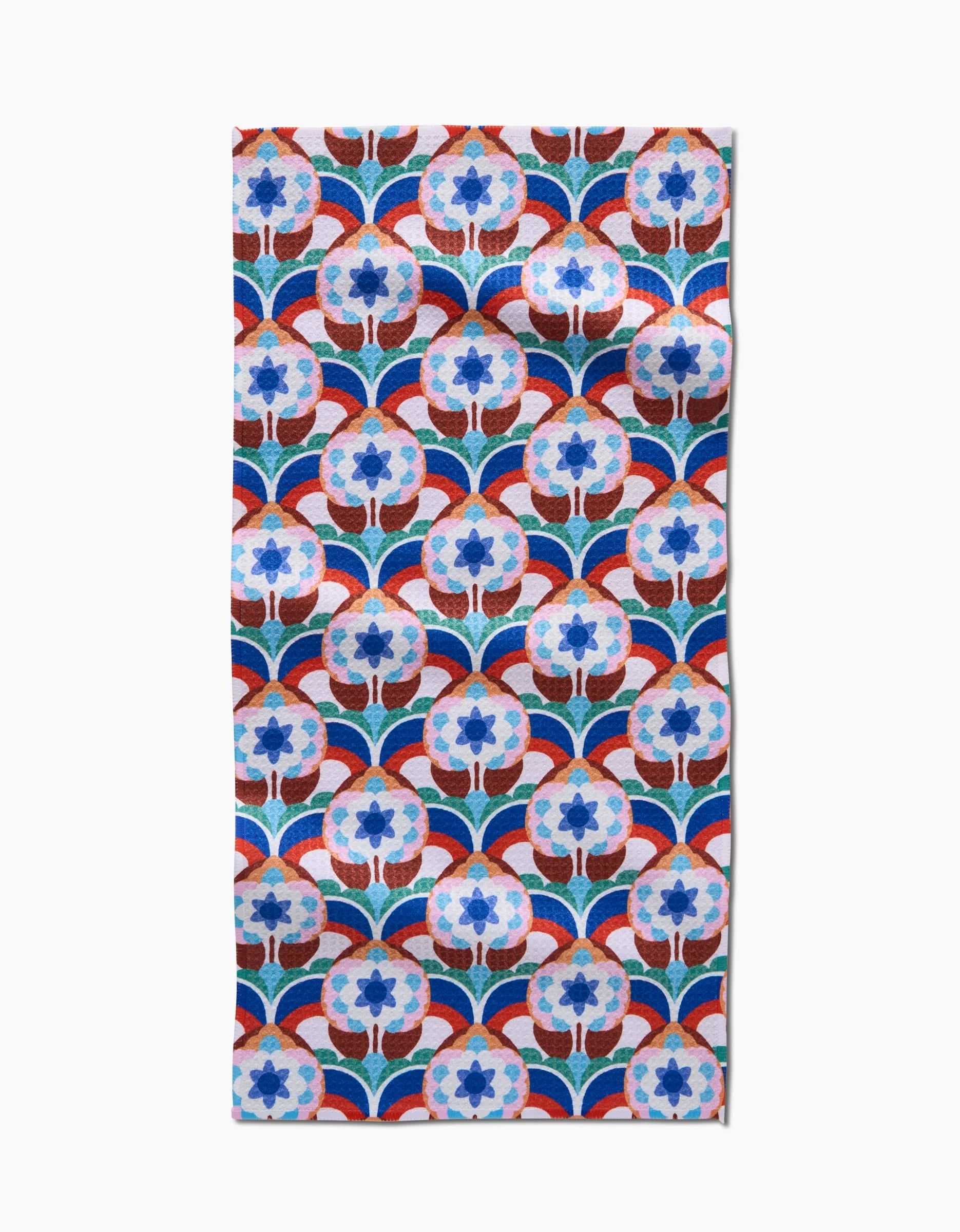 The Seventies Retro Flowers bar towel by Claire Iglesias features a repeating blue, red, and white floral pattern with stylized blooms on a white Geoweave fabric background.