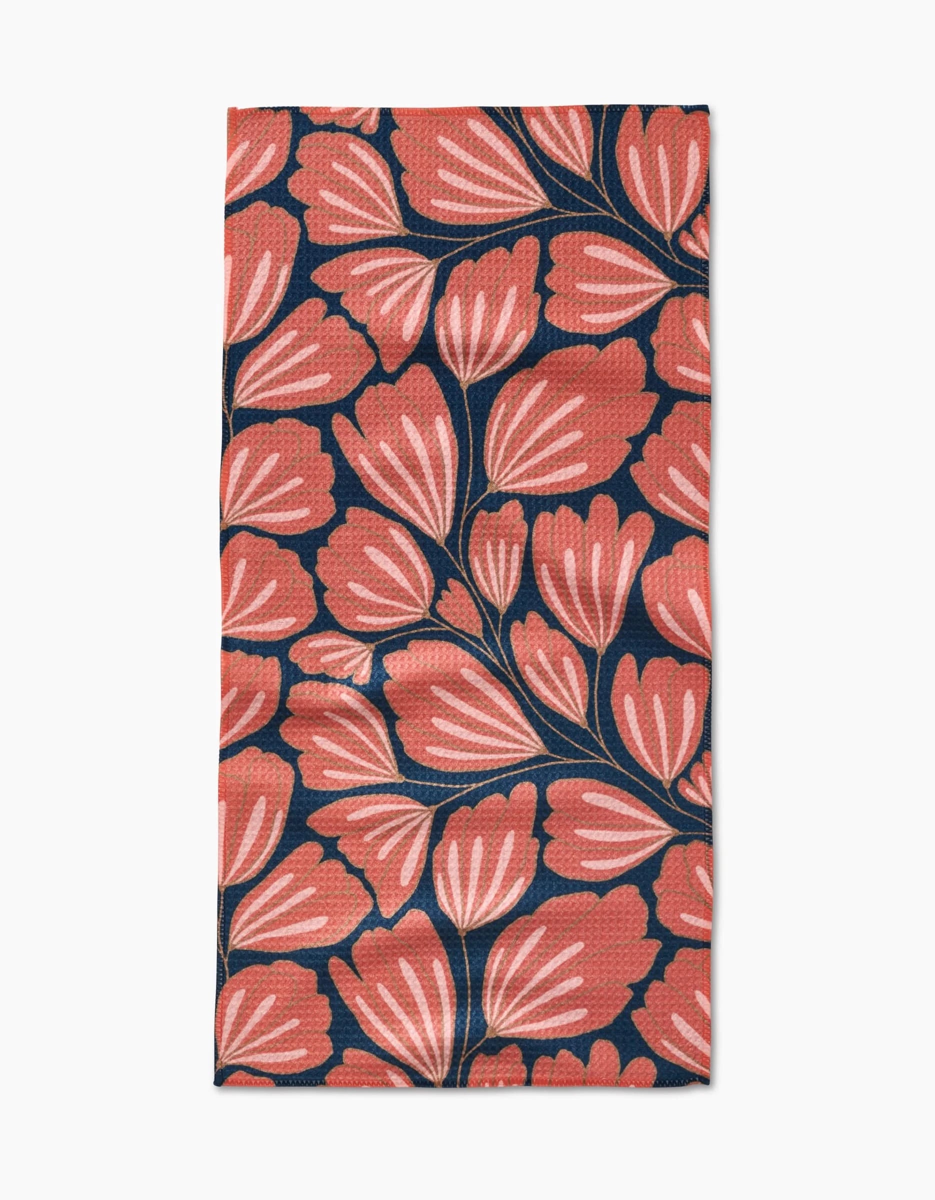 The Sheila bar towel by Amy MacCready is made from Geoweave fabric and showcases large coral flowers with white accents and dark stems on a deep navy blue background.